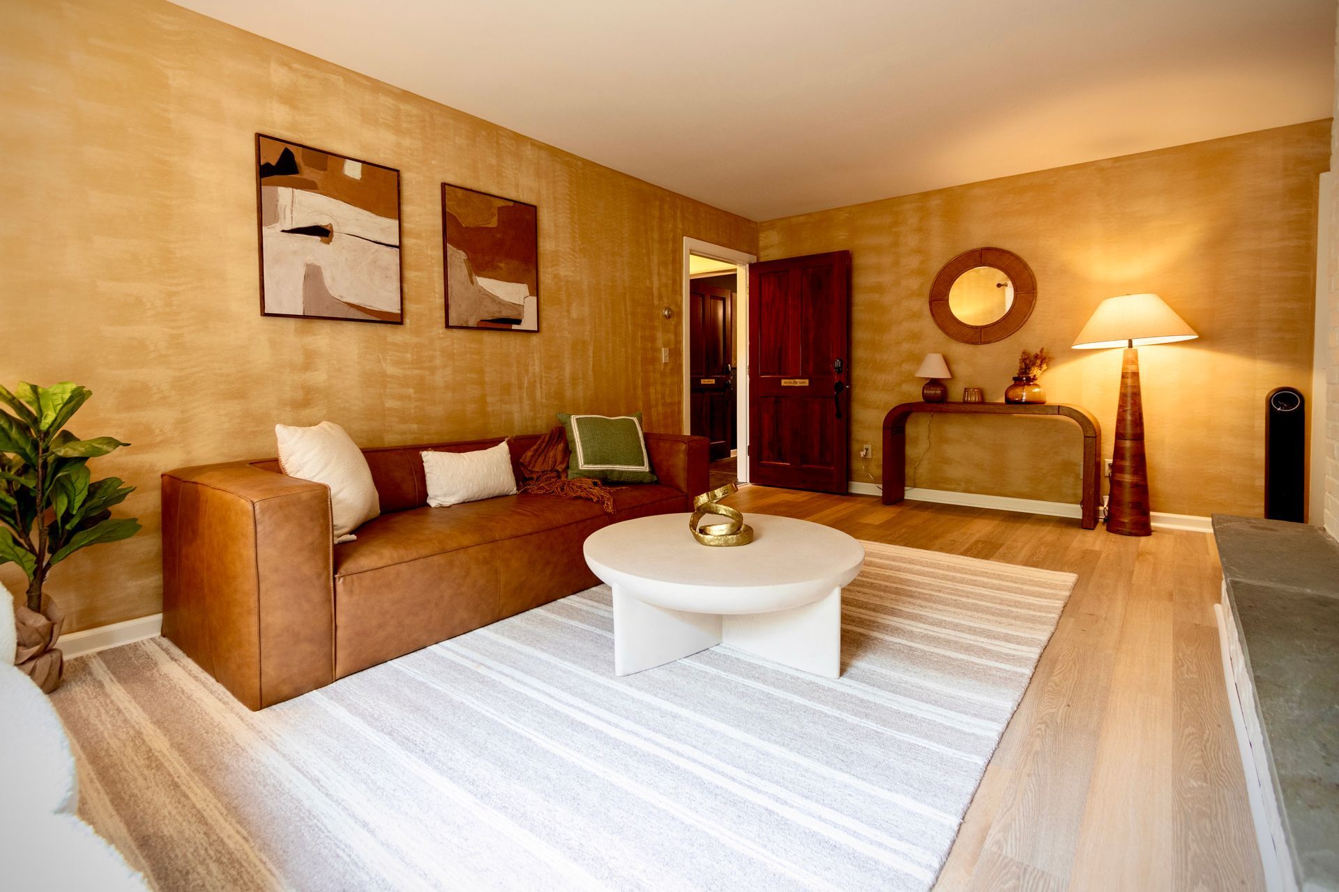 A living room with a brown couch and a white coffee table