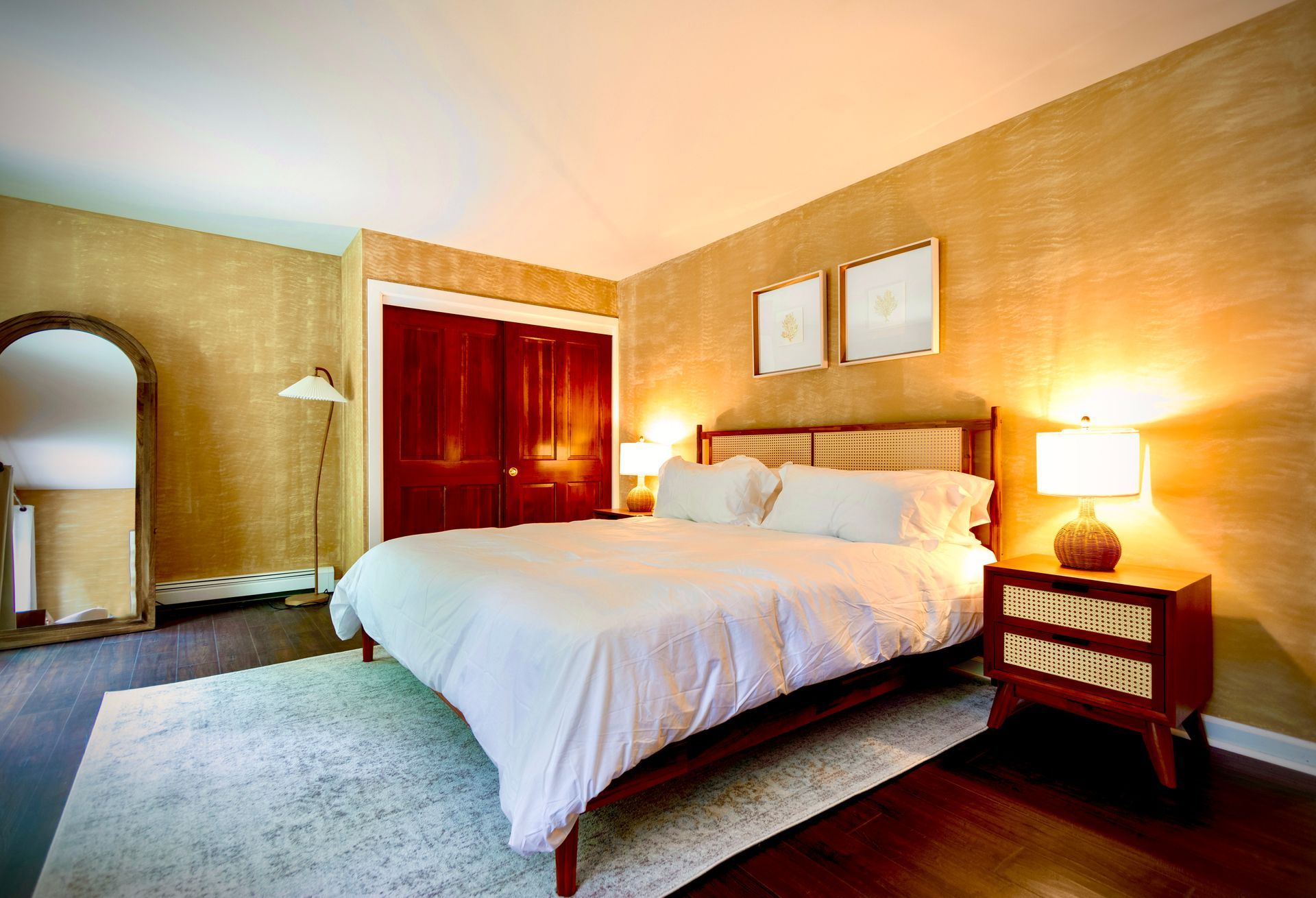 A bedroom with a large bed and a nightstand