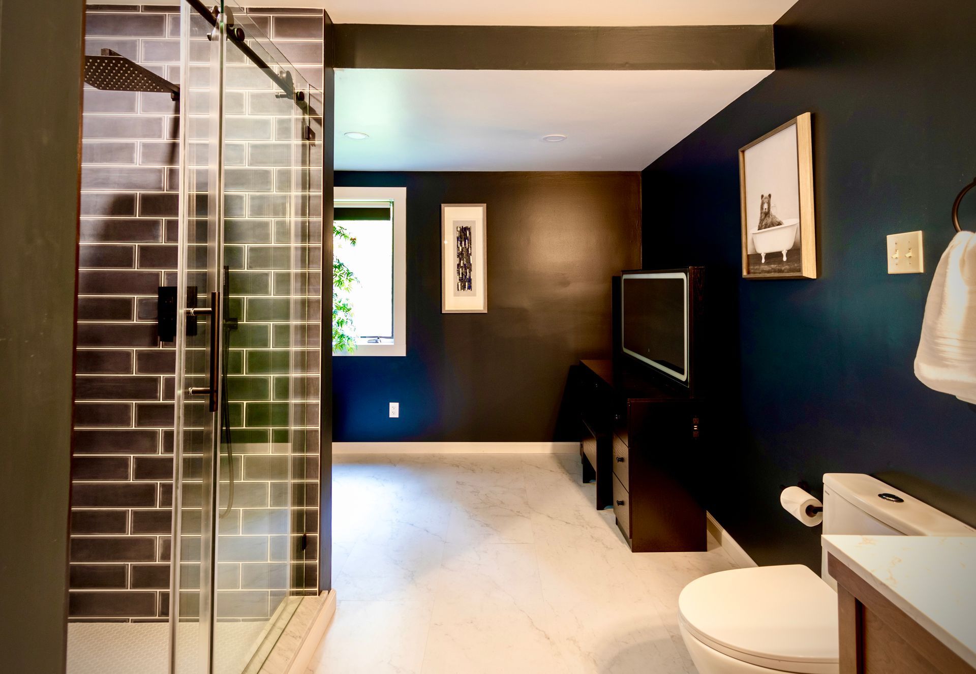 A bathroom with a walk in shower and a toilet