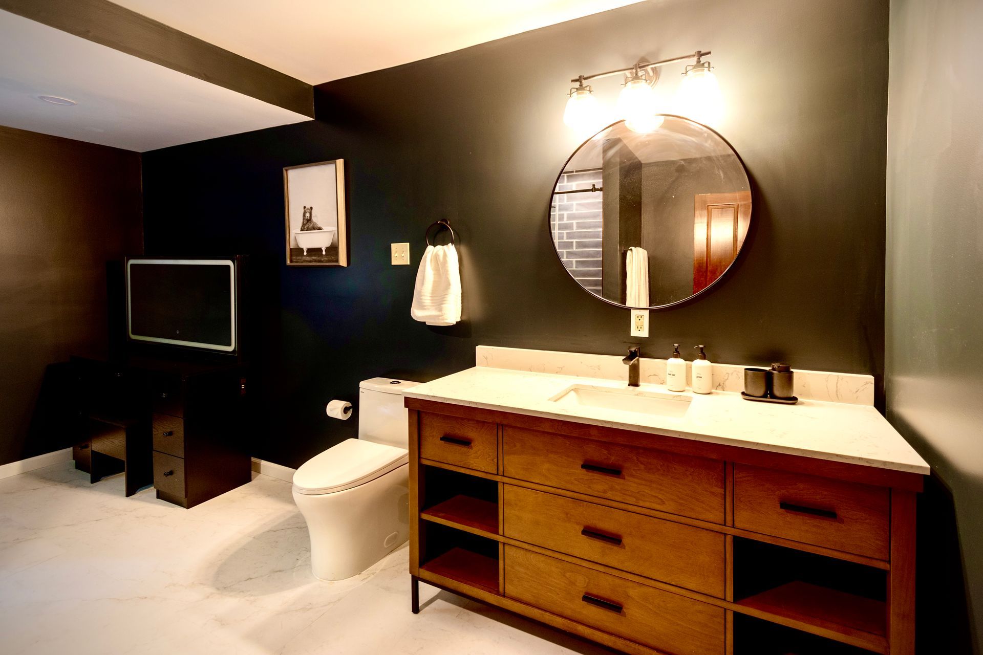 A bathroom with a toilet a sink and a mirror