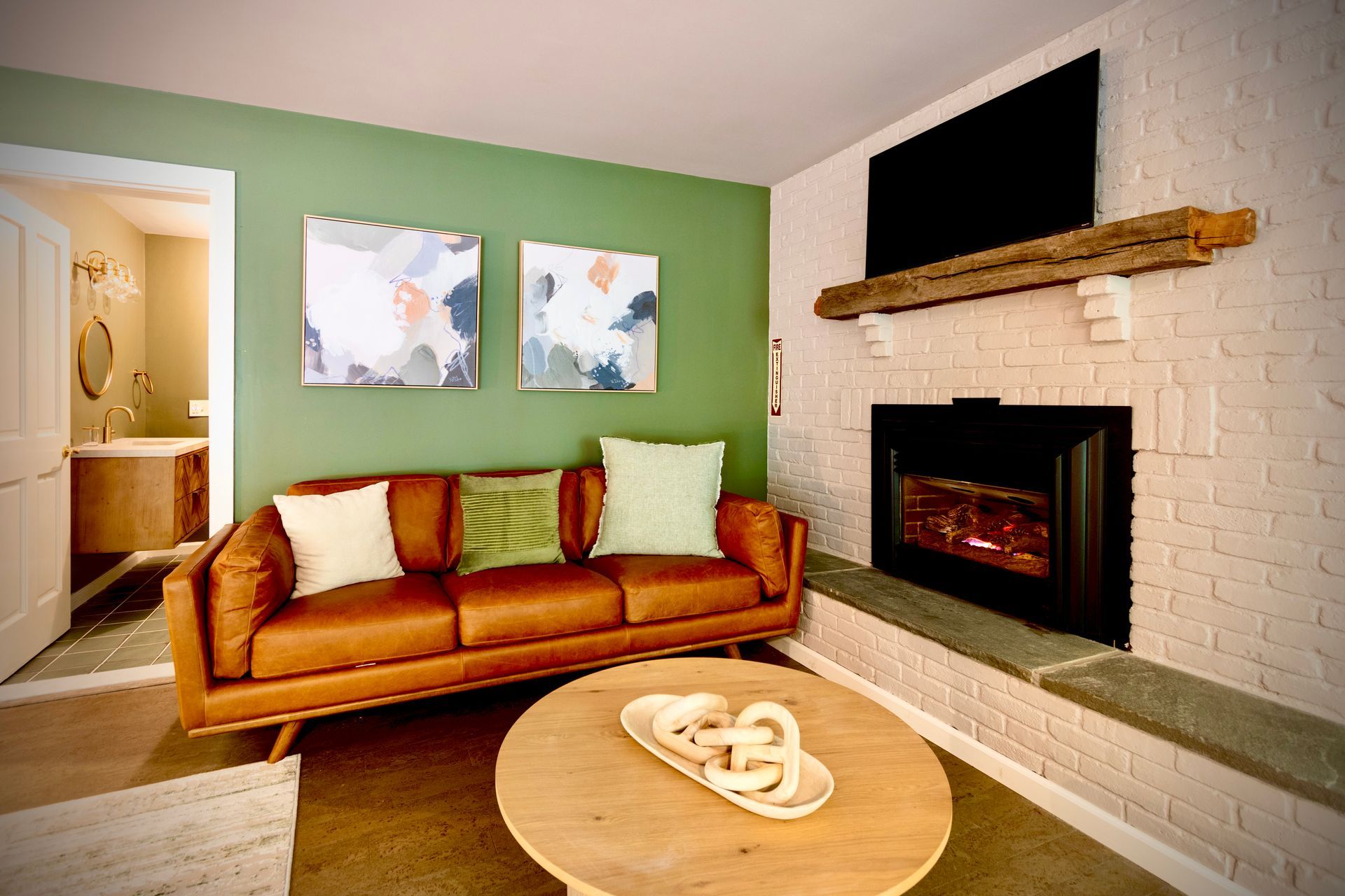 A living room with a couch , fireplace , and television.