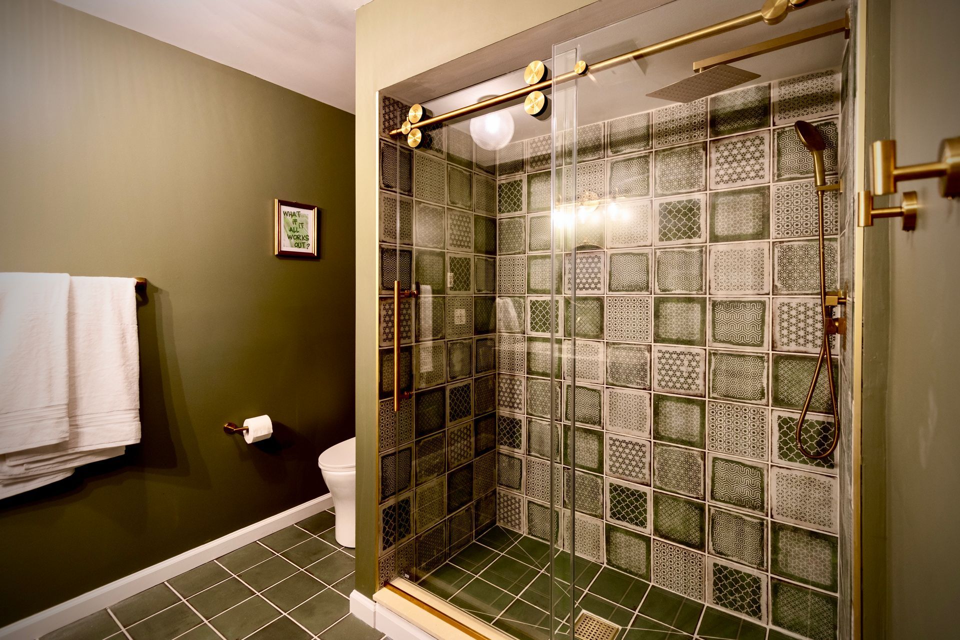 A bathroom with a walk in shower and a toilet.