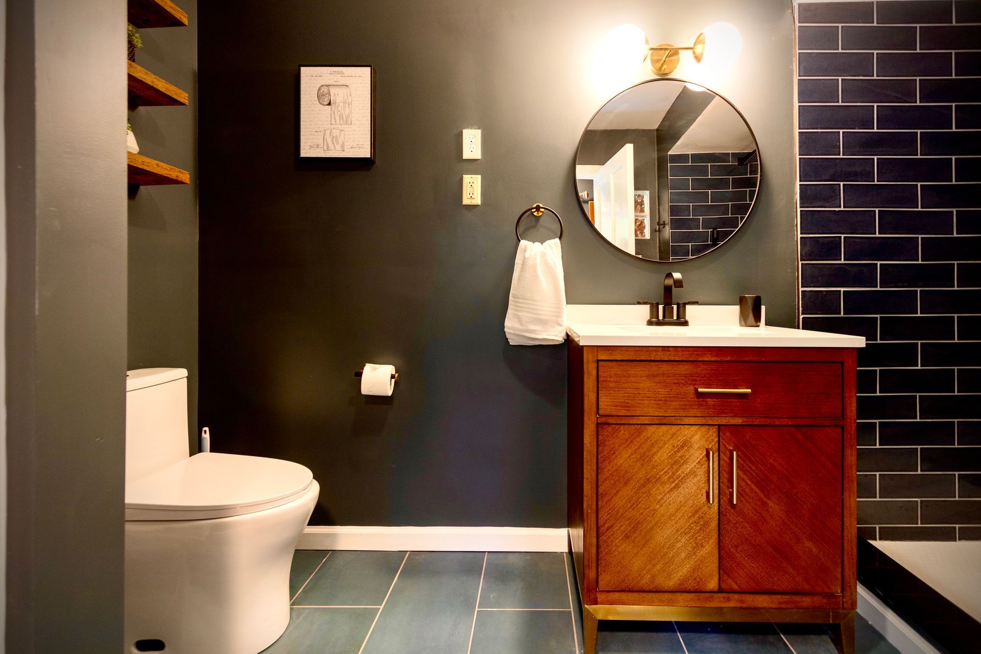 A bathroom with a toilet a sink and a mirror
