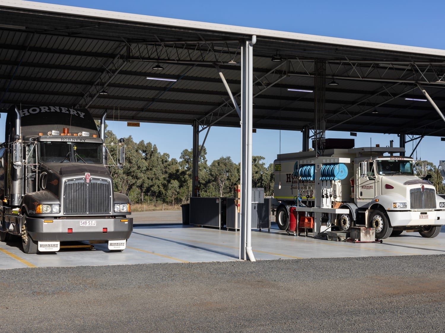 a kenworth truck is parked under a covered area