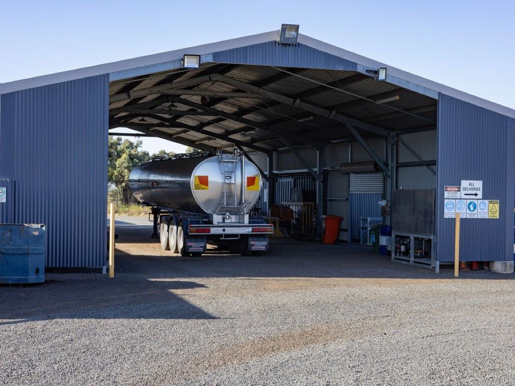 a truck is parked under a roof in a garage .