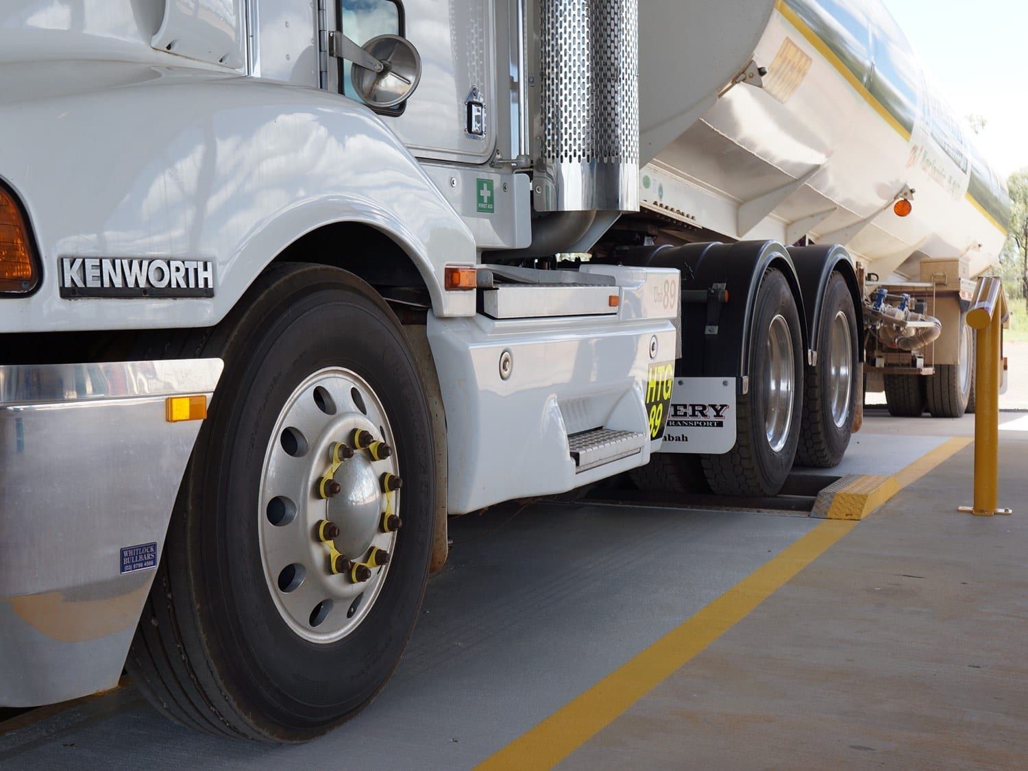 a kenworth semi truck is parked in a parking lot