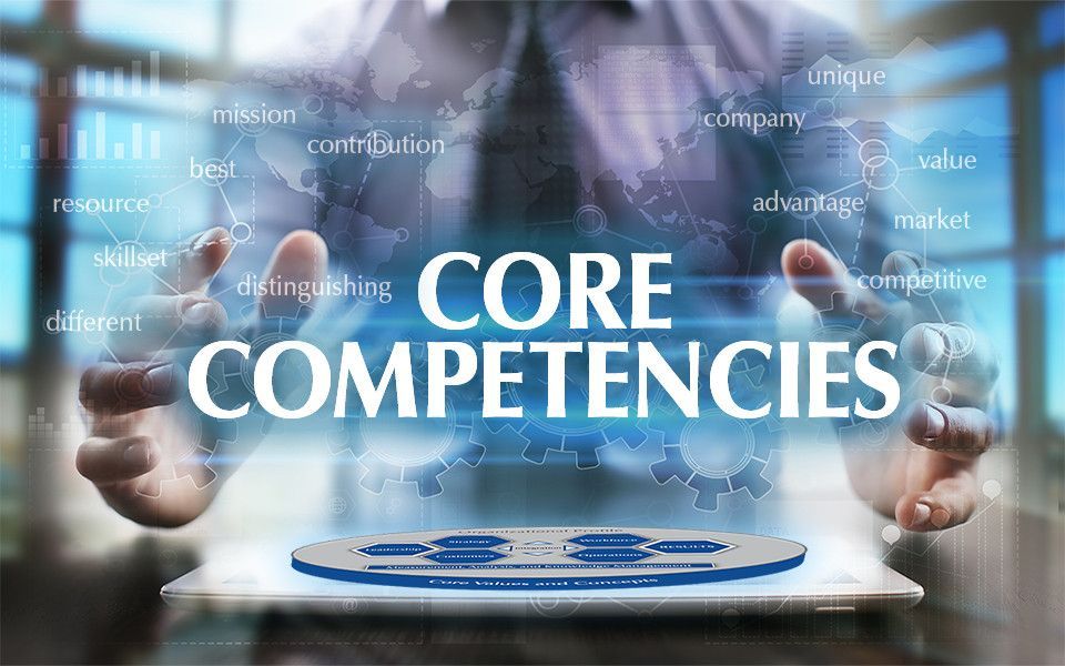 Hands holding a tablet with “CORE COMPETENCIES” and floating business terms in the background