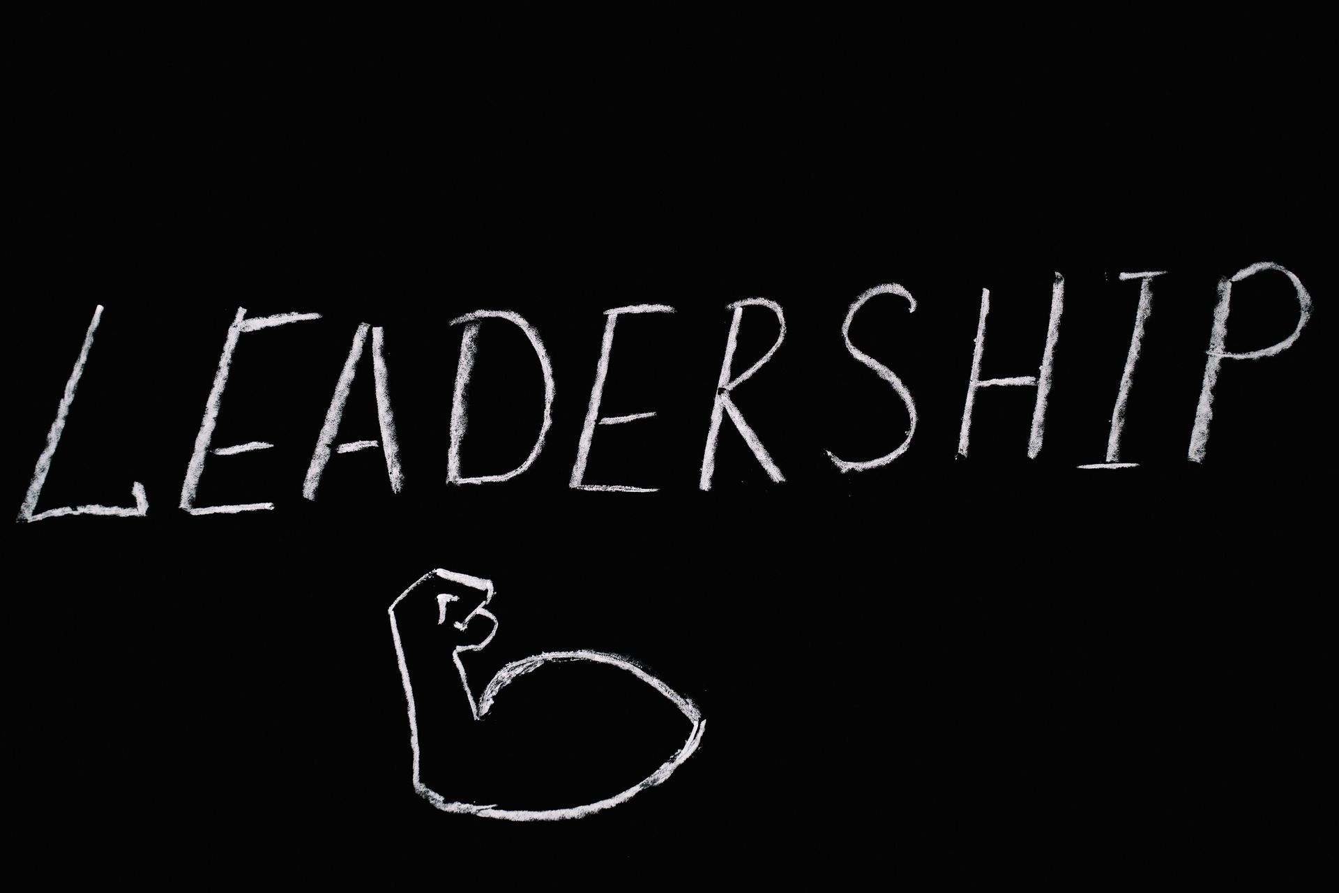 Handwritten white “LEADERSHIP” with a sketched letter B on a black background