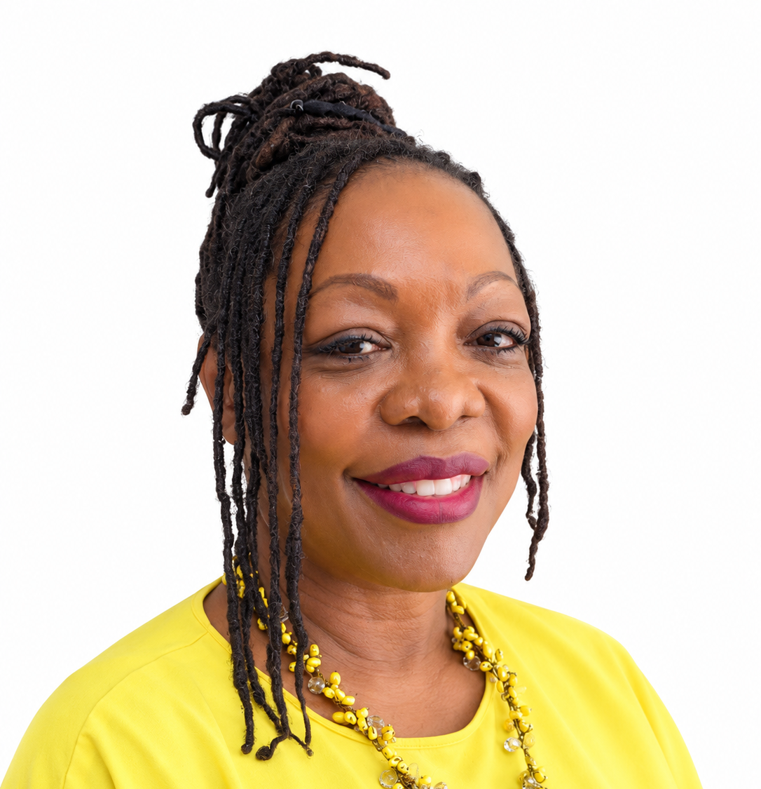 Smiling woman with braided hair in a yellow top and necklace on a white background