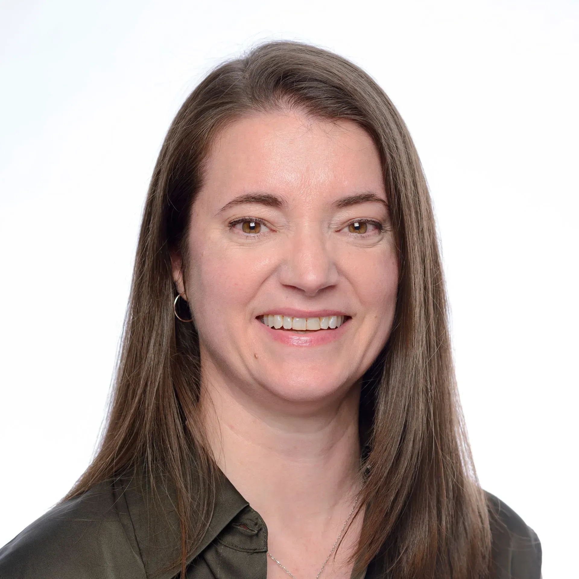 Portrait of a smiling woman with long brown hair on a white background