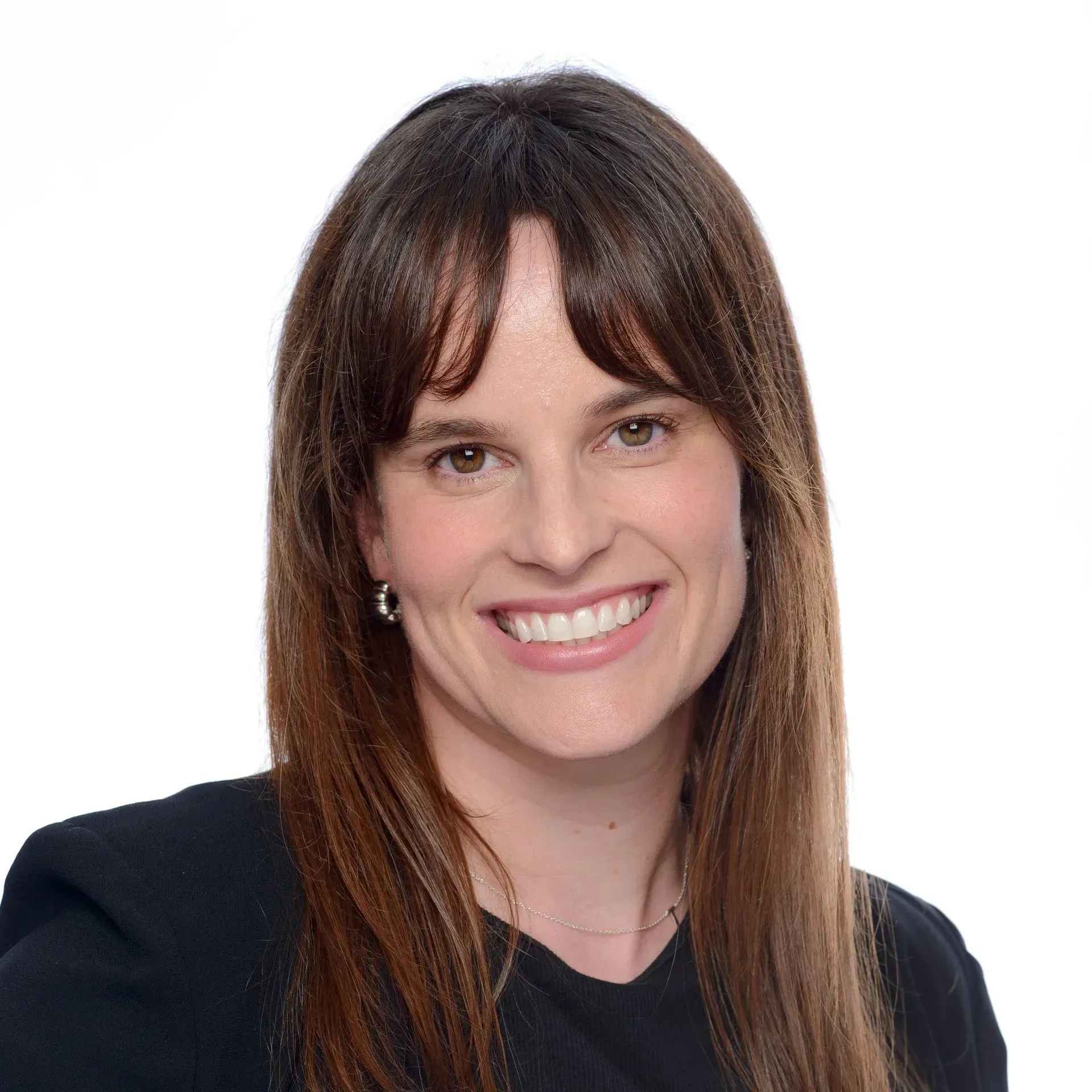 Smiling woman with long brown hair against a white background
