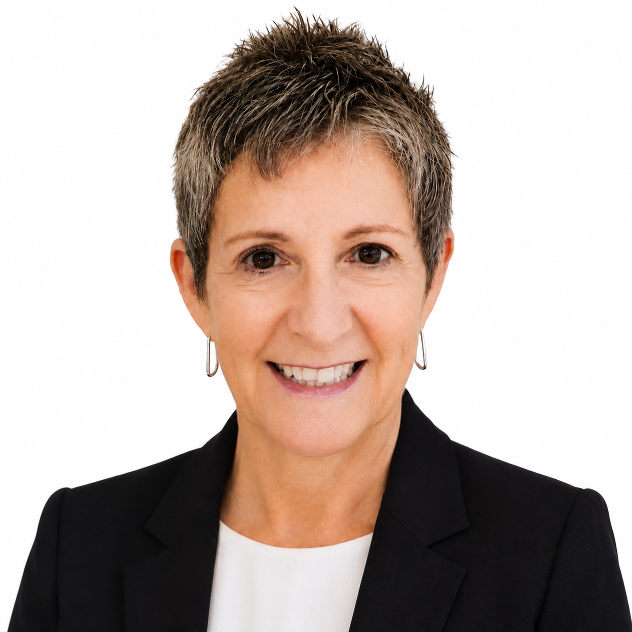 Smiling professional in navy blazer and white blouse against a light background