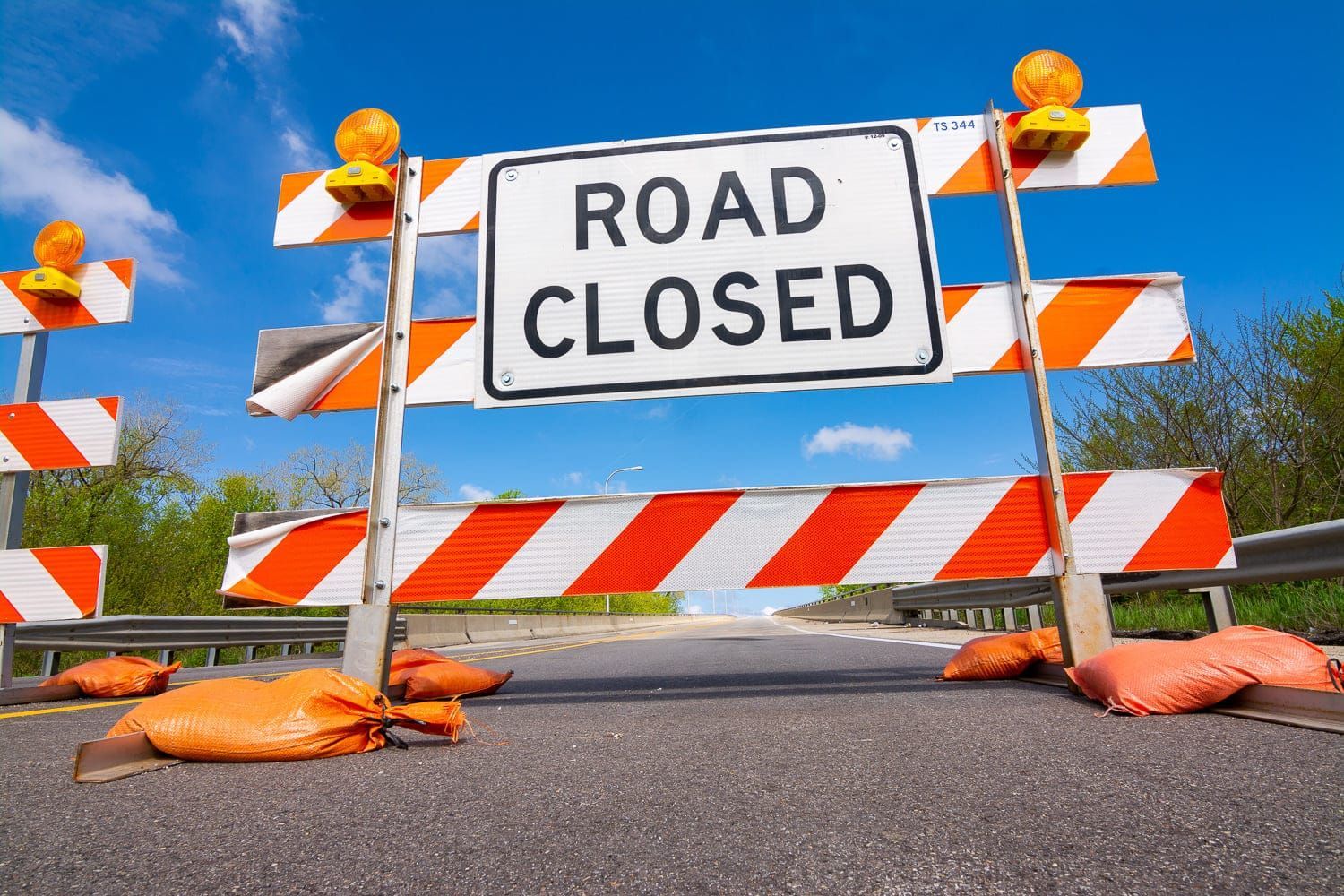 A road sign that says road closed on it