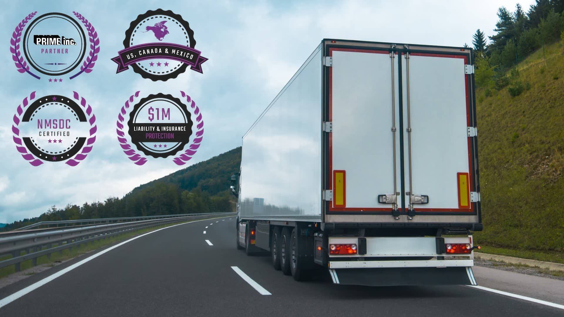 A white semi truck is driving down a highway.