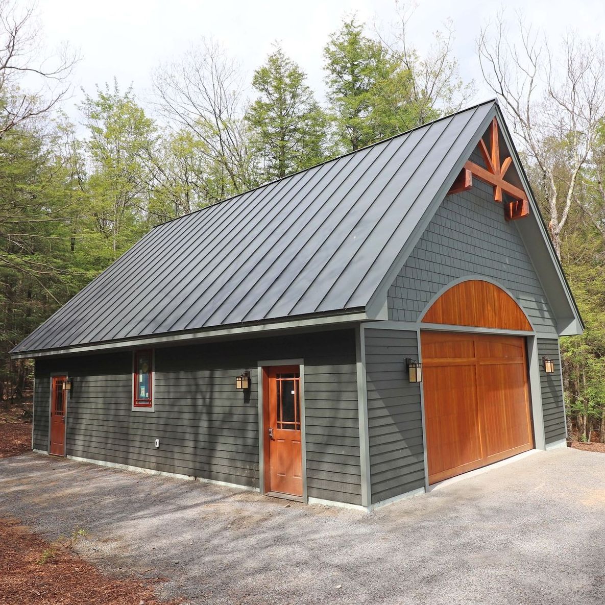 A garage with a metal roof and a wooden door