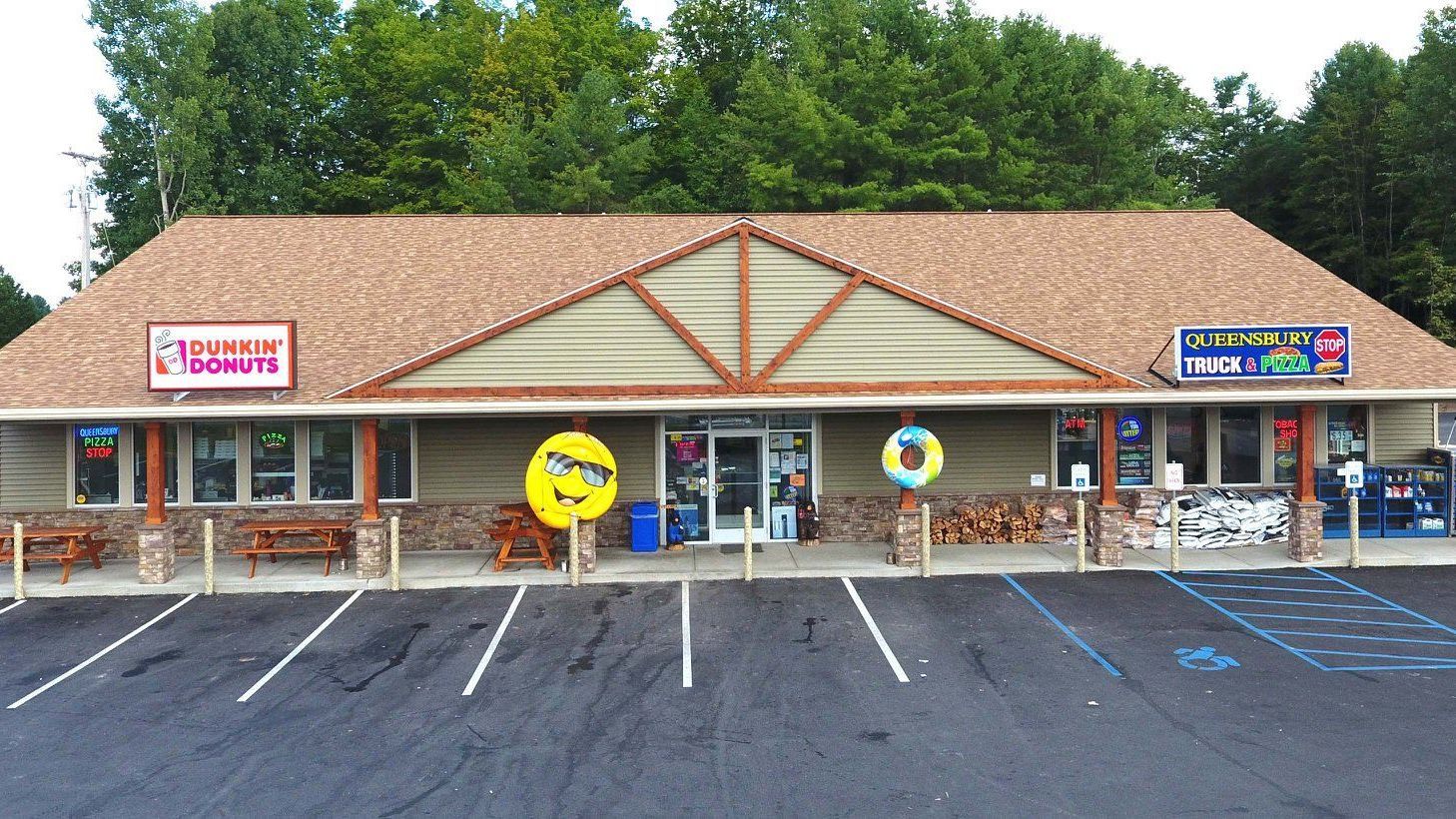 A store front with a sign that says dunkin donuts