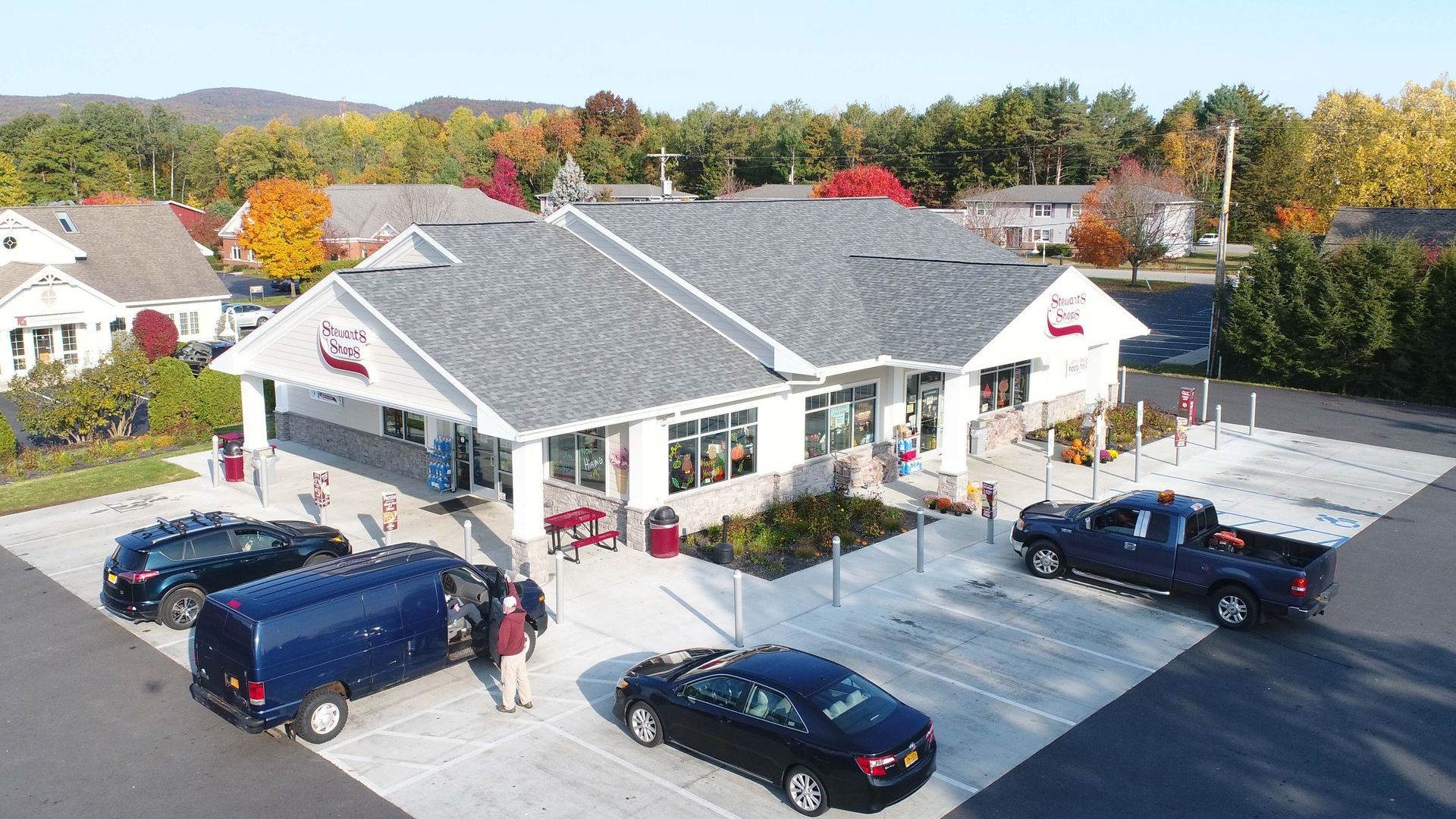 An aerial view of a building with cars parked in front of it