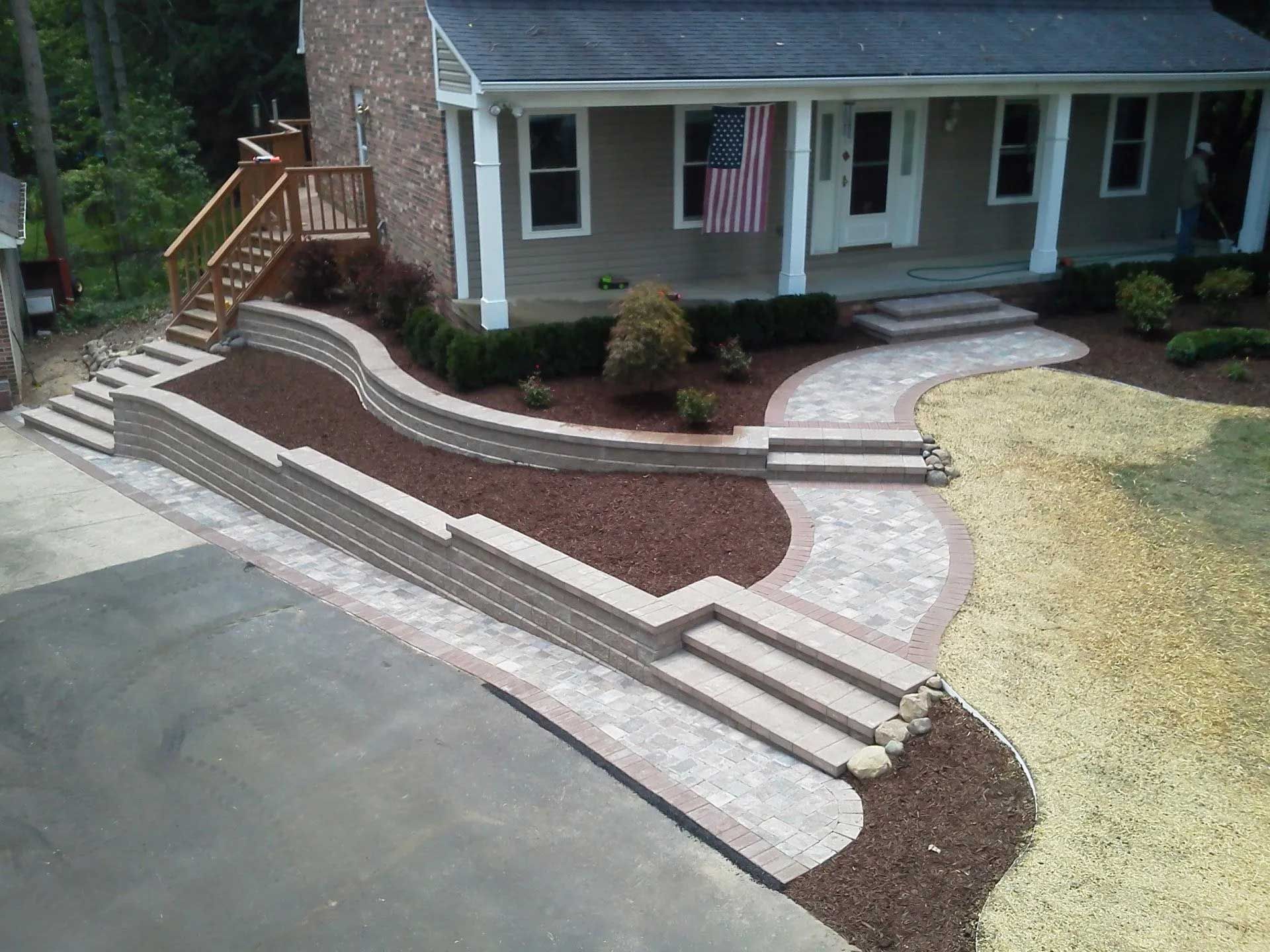 A house with a walkway and stairs in front of it