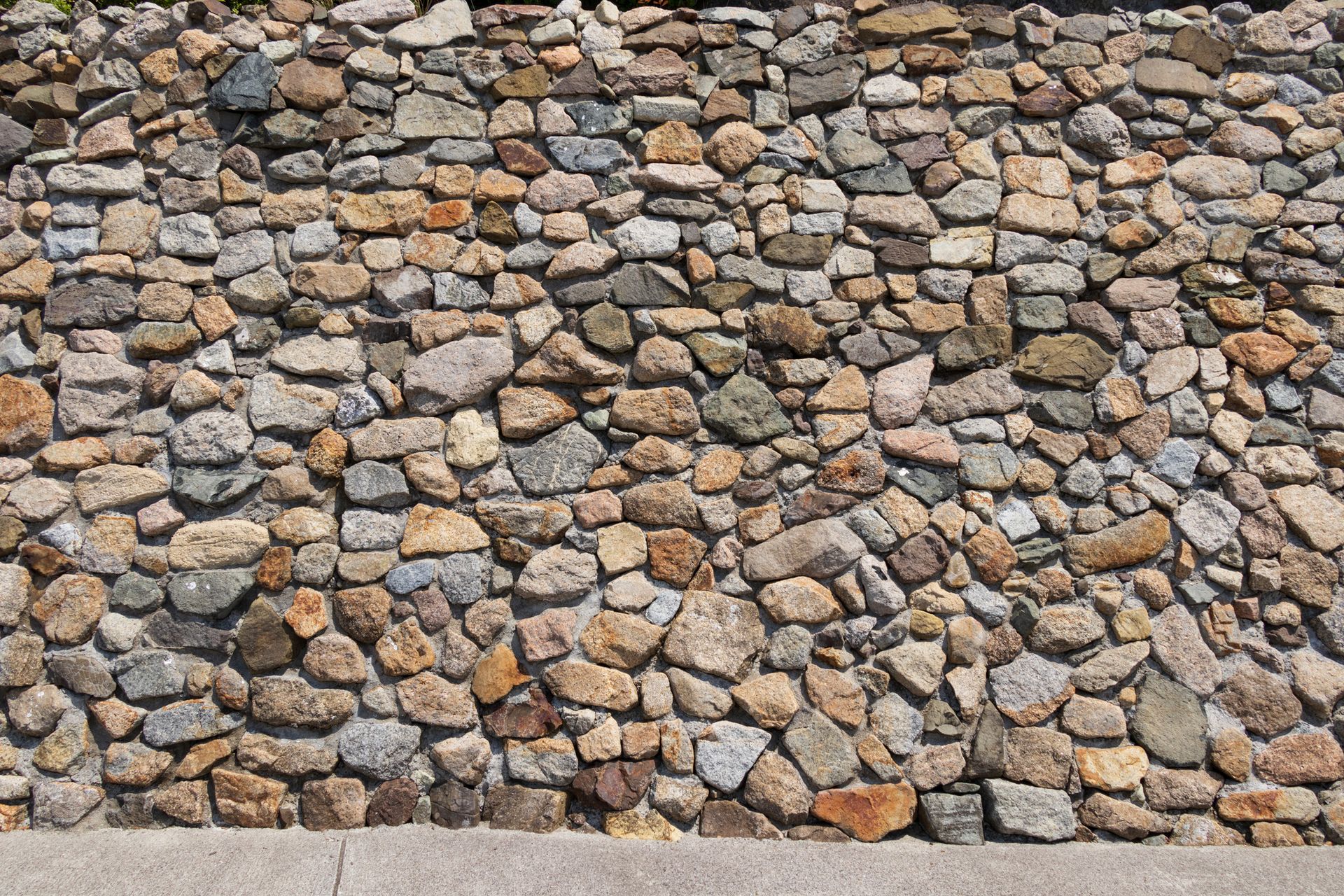 A large pile of rocks sitting on top of a concrete surface.