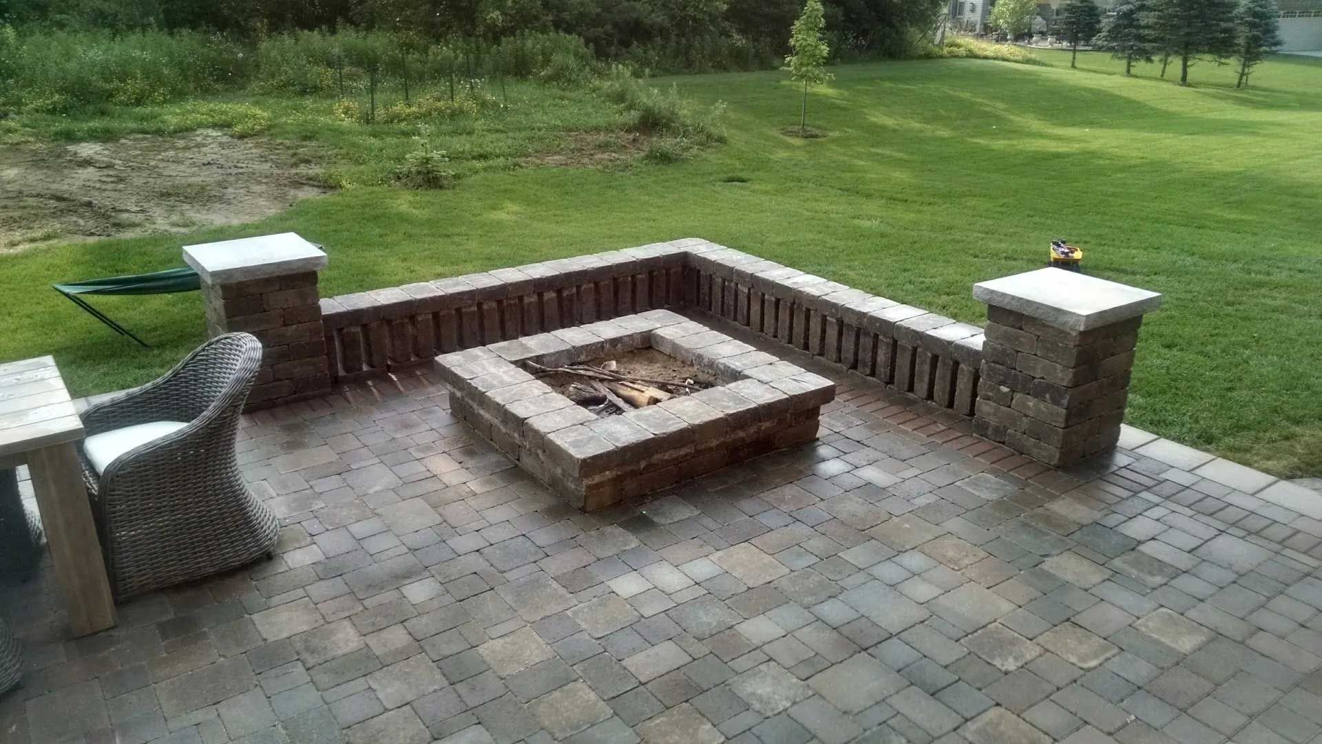 There is a fire pit in the middle of the patio.