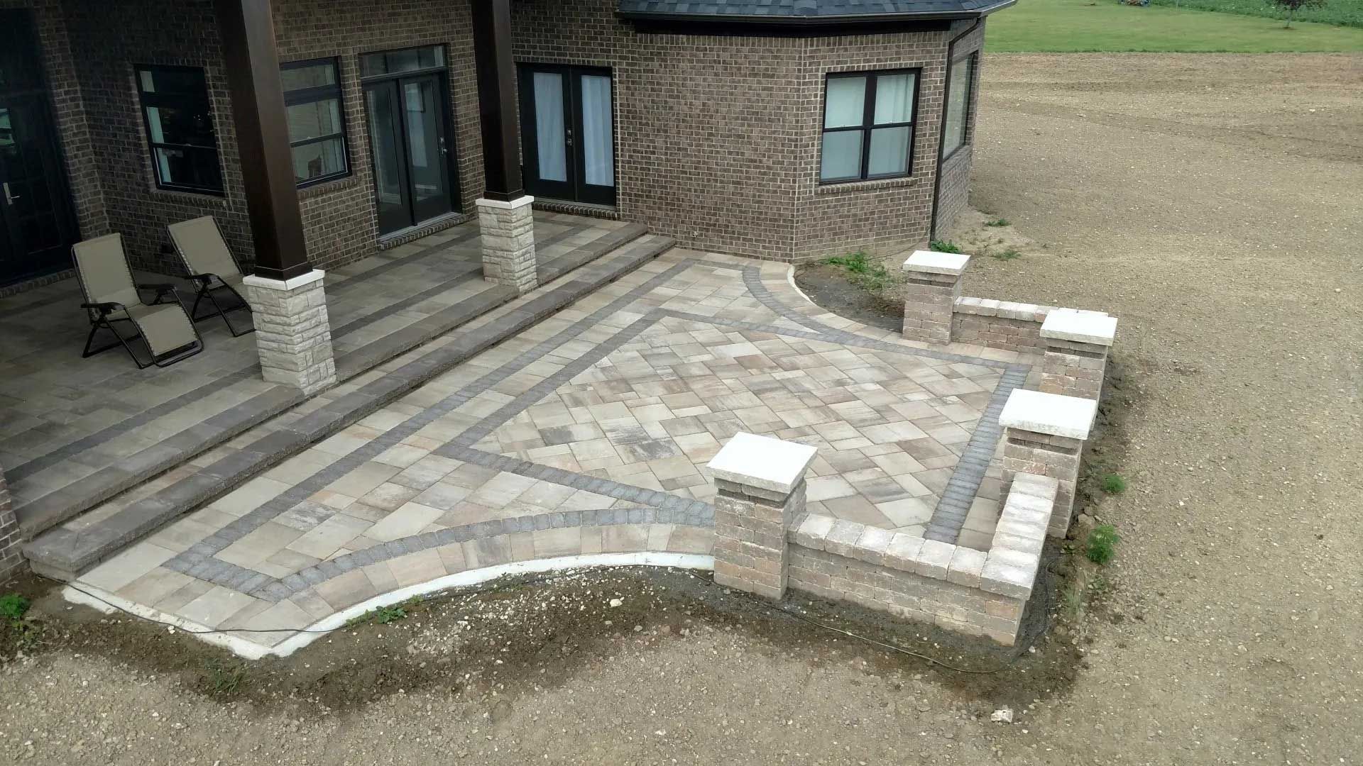 An aerial view of a patio in front of a house.