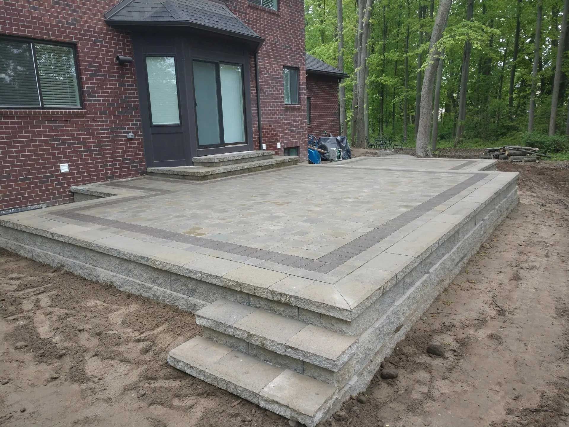 A brick house with a patio in front of it