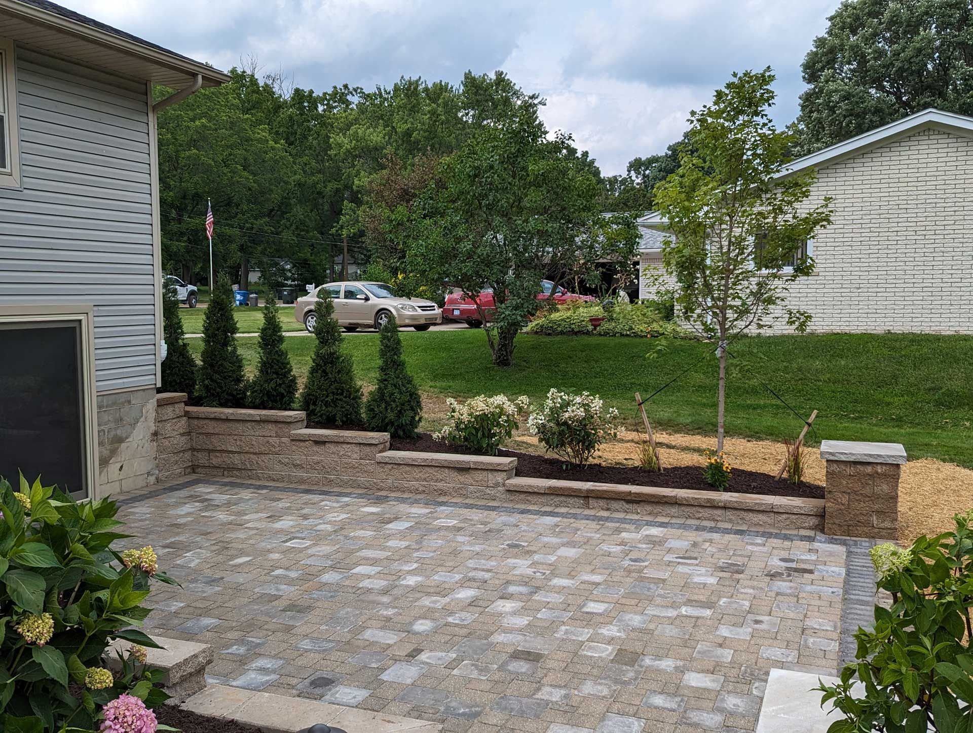 A house with a patio and trees in front of it.