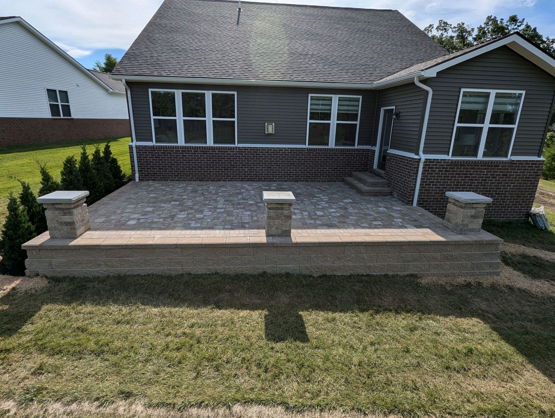 A house with a large patio in front of it.