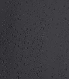 A close up of water drops on a black surface.