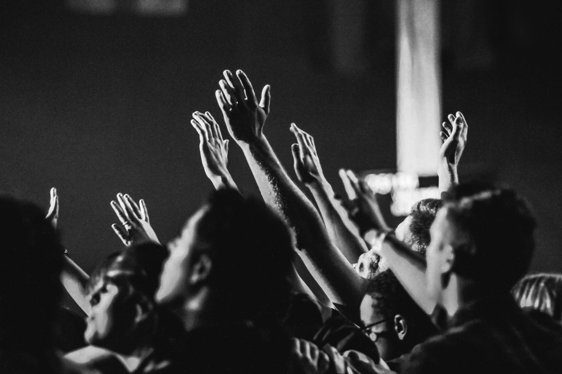 people praising the Lord with arms lifted up