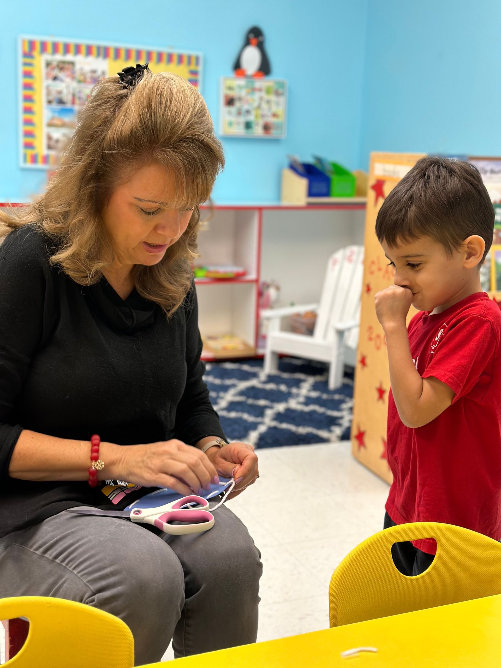 A woman is reading a book to a group of children