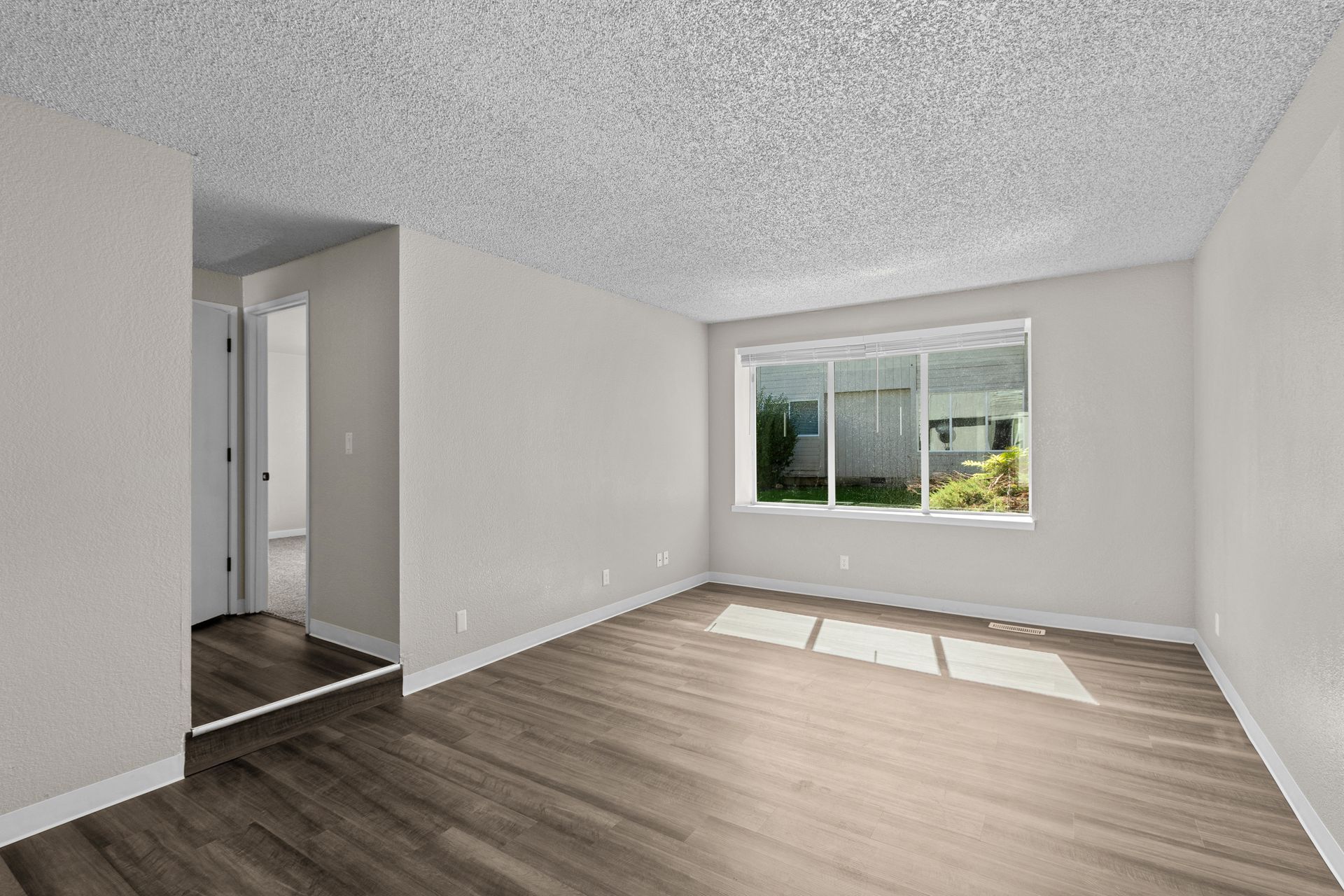 Spacious step-down living room with large window