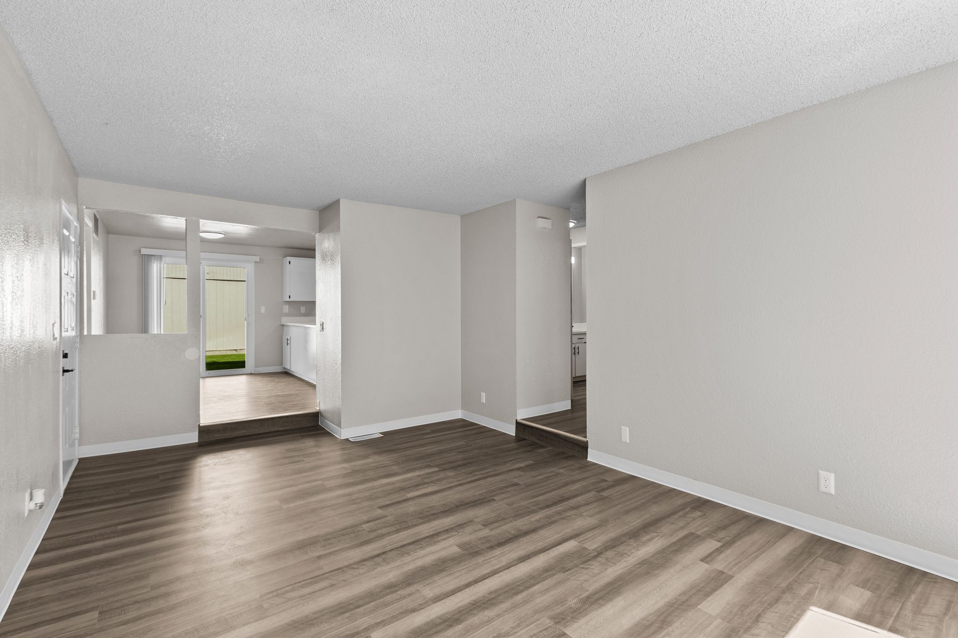 Spacious step-down living room with large window