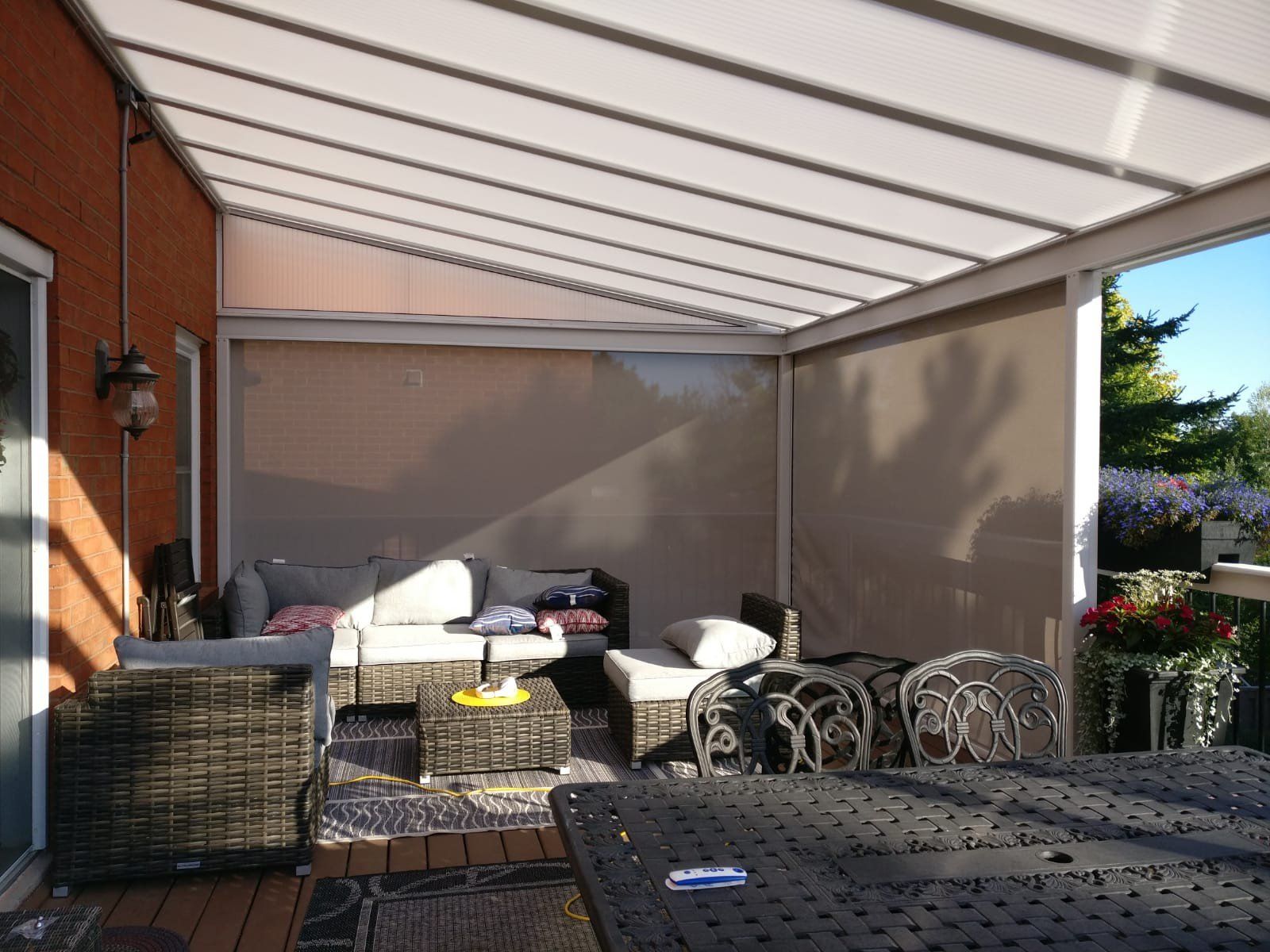 A patio with a table and chairs under a canopy