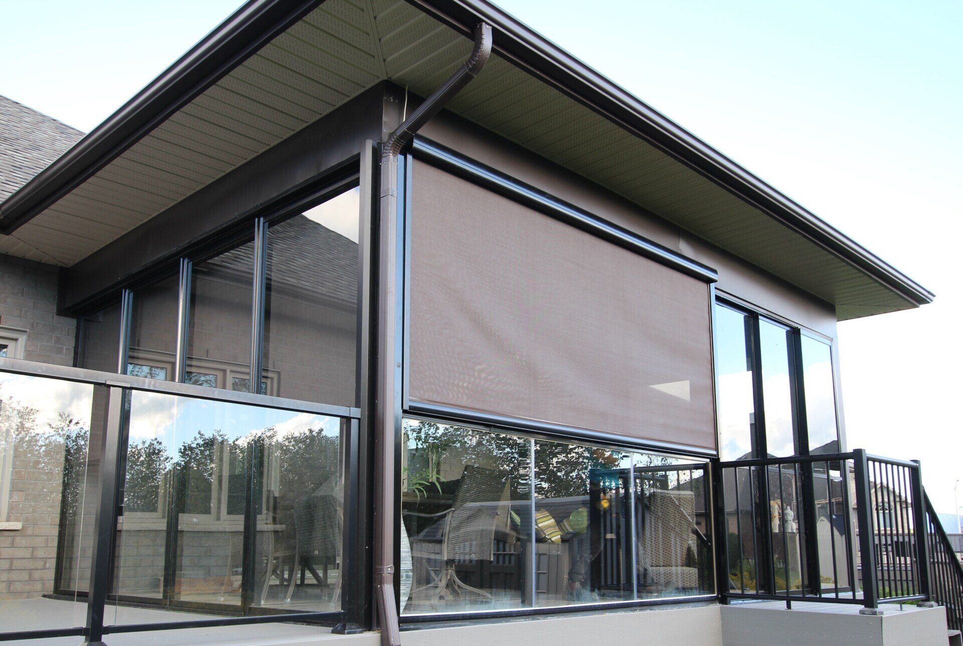 A large house with a screened in porch and a balcony