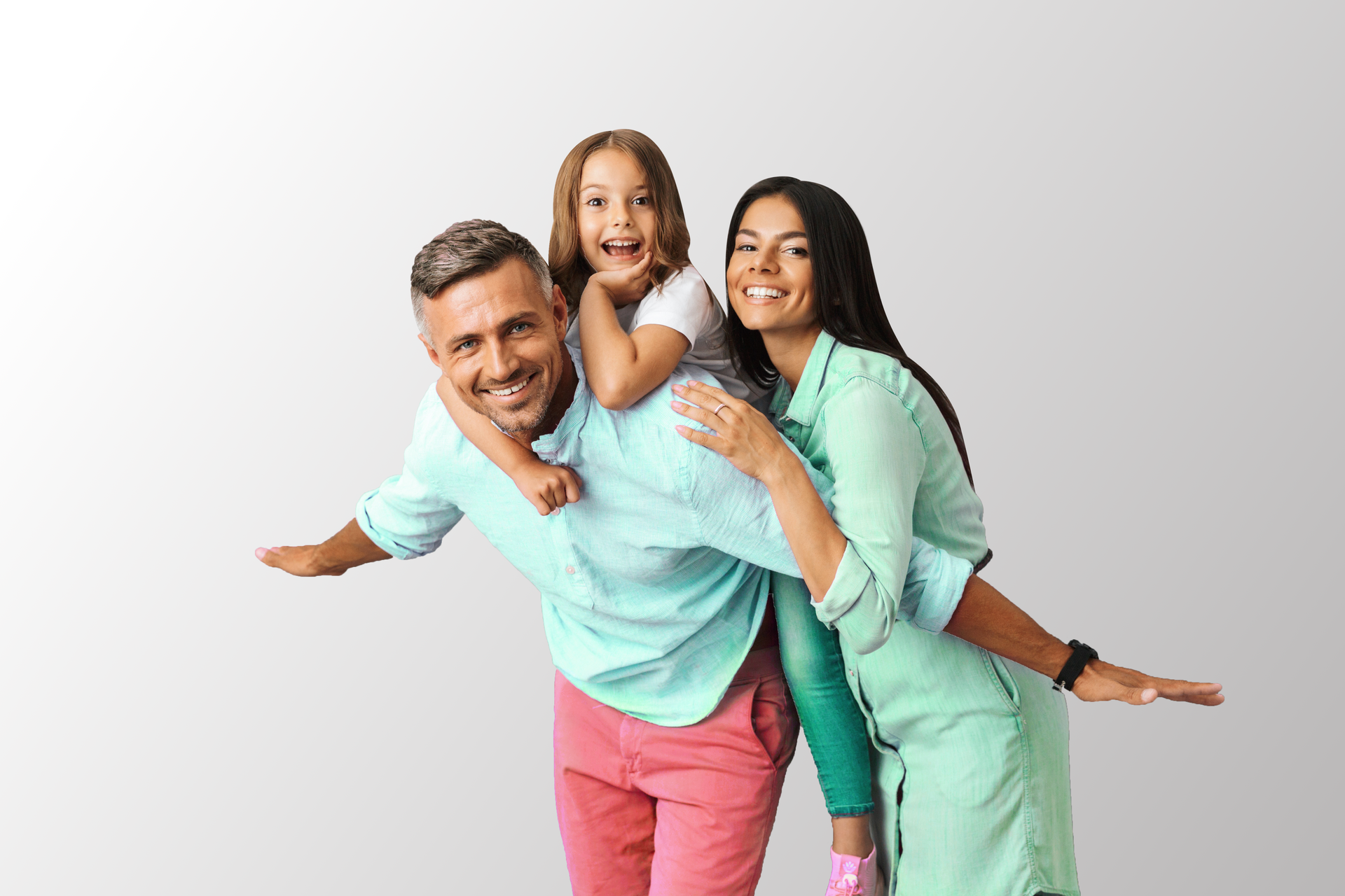 Three smiling people posing on a white background, with one carrying a child on their back