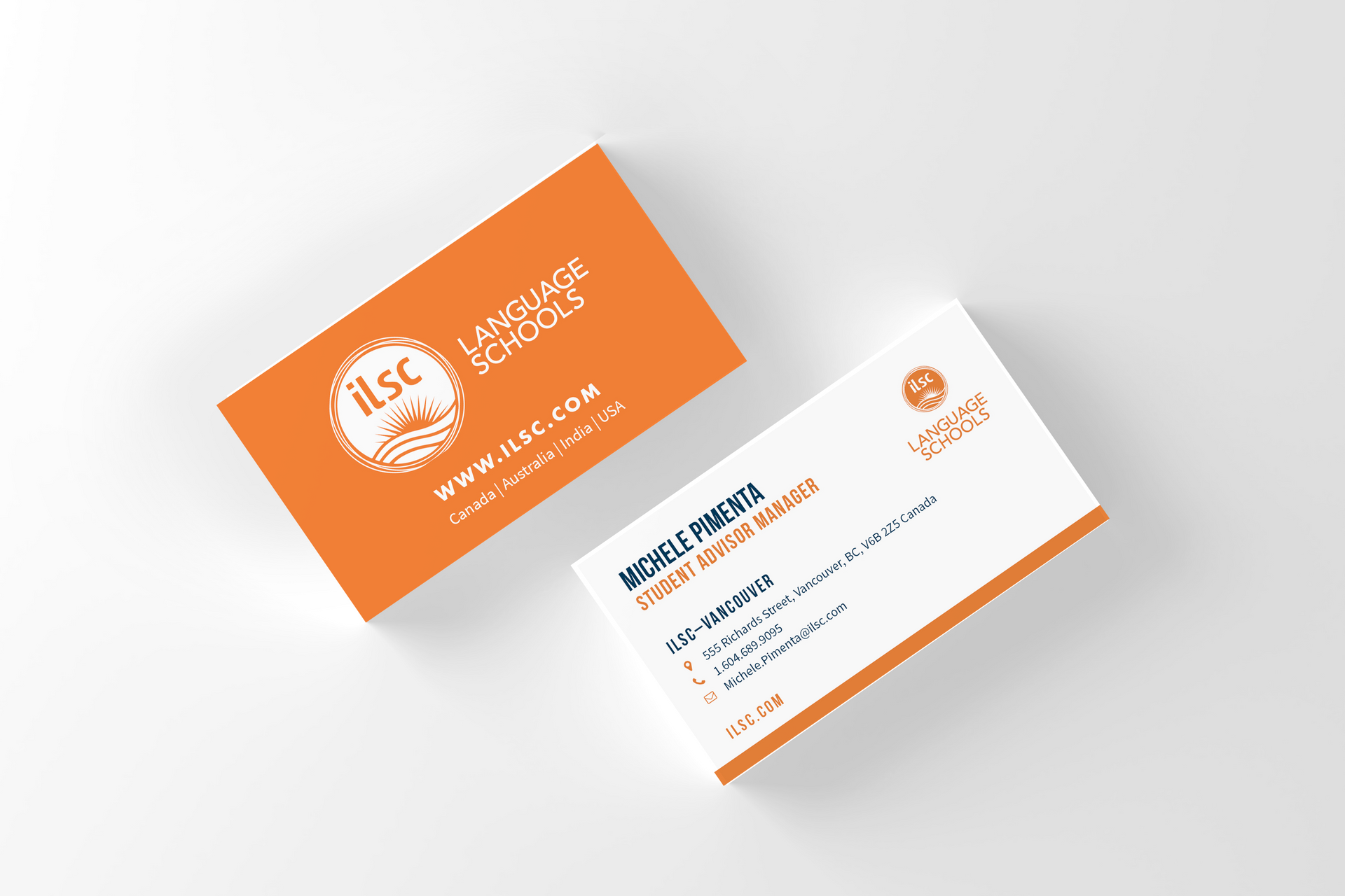 Two orange-and-white business cards with the ILSC logo on a light background