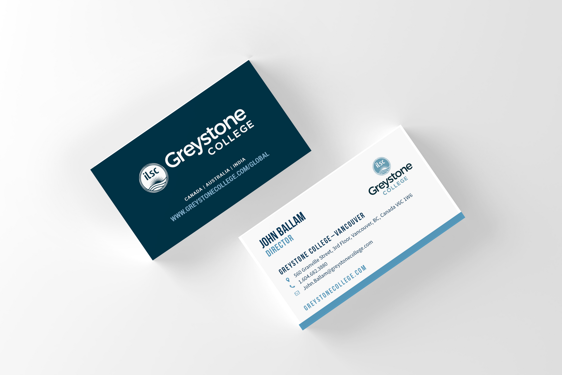 Two overlapping business cards, one dark teal and one white, on a light gray background.