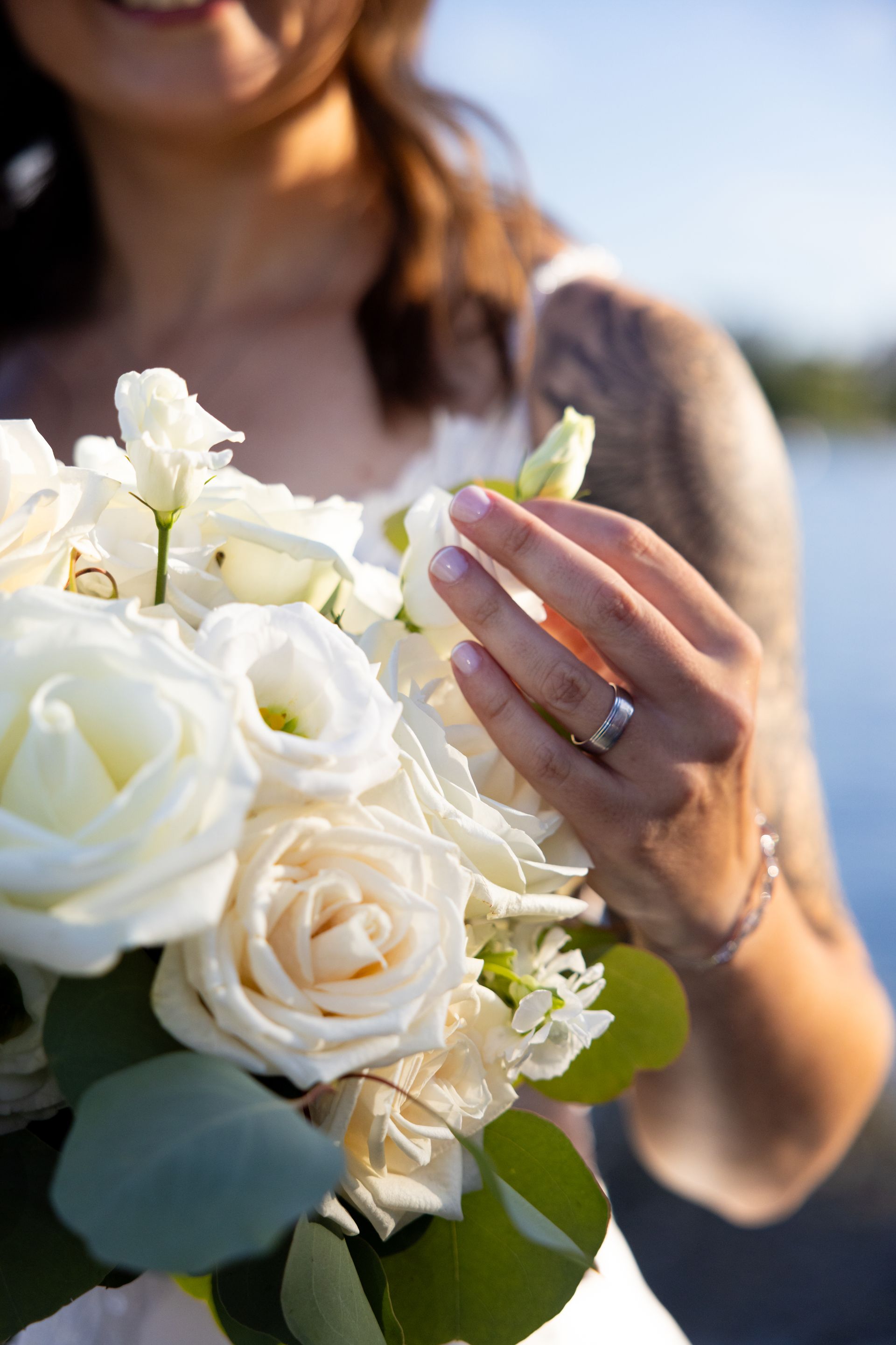 Woman holding a white rose bouquet outdoors