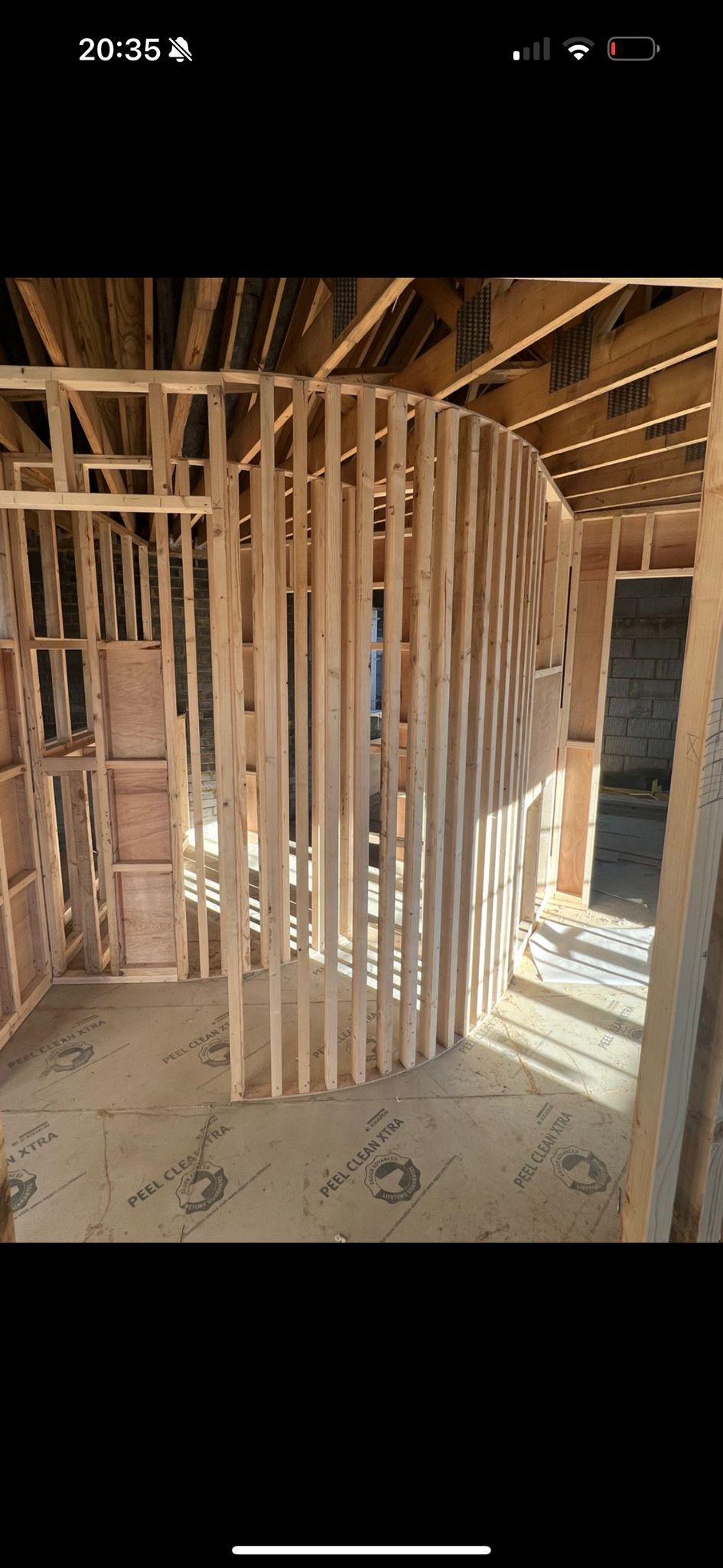 Interior of a building under construction, wooden framing visible.