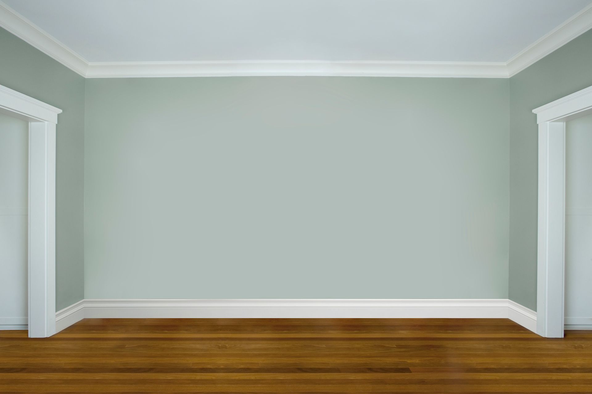 An empty room with two doors and a wooden floor.