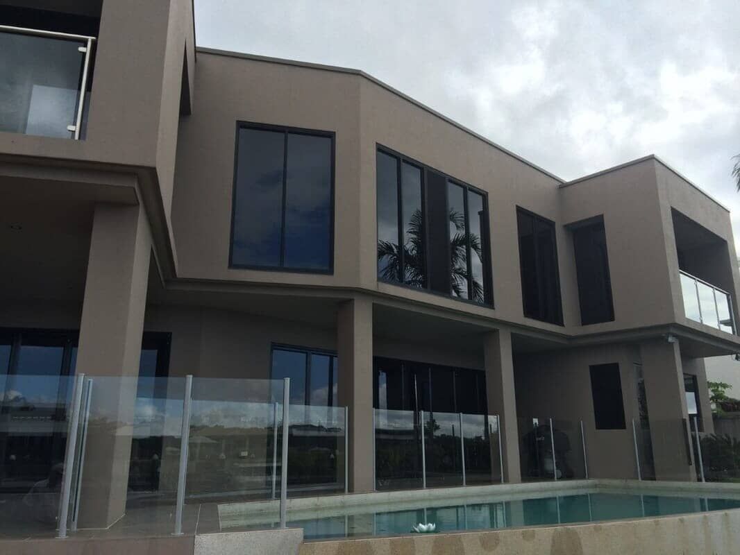 A Large House With A Swimming Pool In Front Of It — Pete's Painting Solutions In Cairns North, QLD