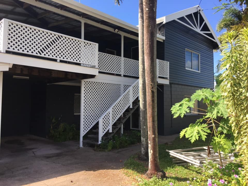 Two-story Building With Dark Siding, White Latticework Railings — Pete's Painting Solutions In Cairns, QLD