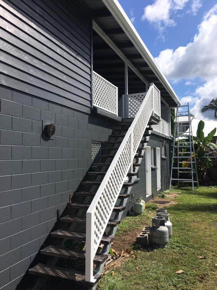 Exterior of a Two-story Building With a Staircase Leading to a Balcony — Pete's Painting Solutions In Cairns, QLD