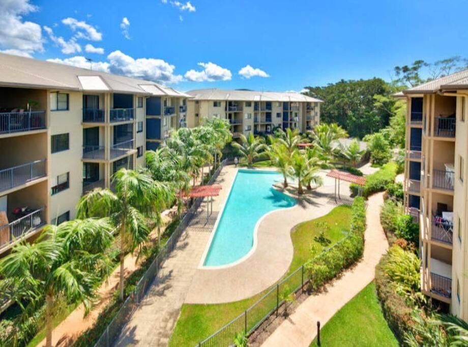 Apartment Complex With a Pool, Palm Trees — Pete's Painting Solutions In Cairns, QLD