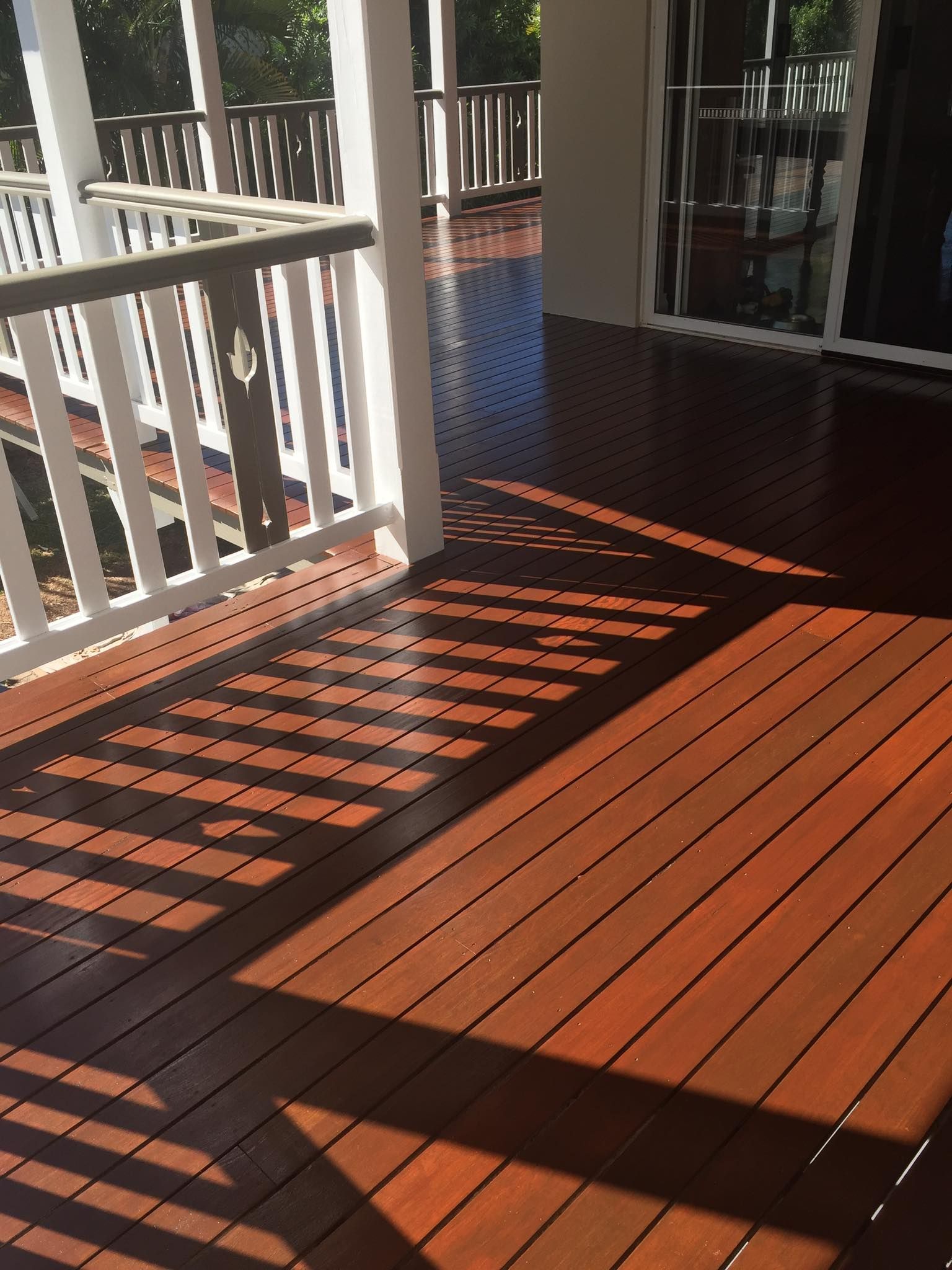 A Person Is Painting A Piece Of Wood With A Brush — Pete's Painting Solutions In Cairns, QLD