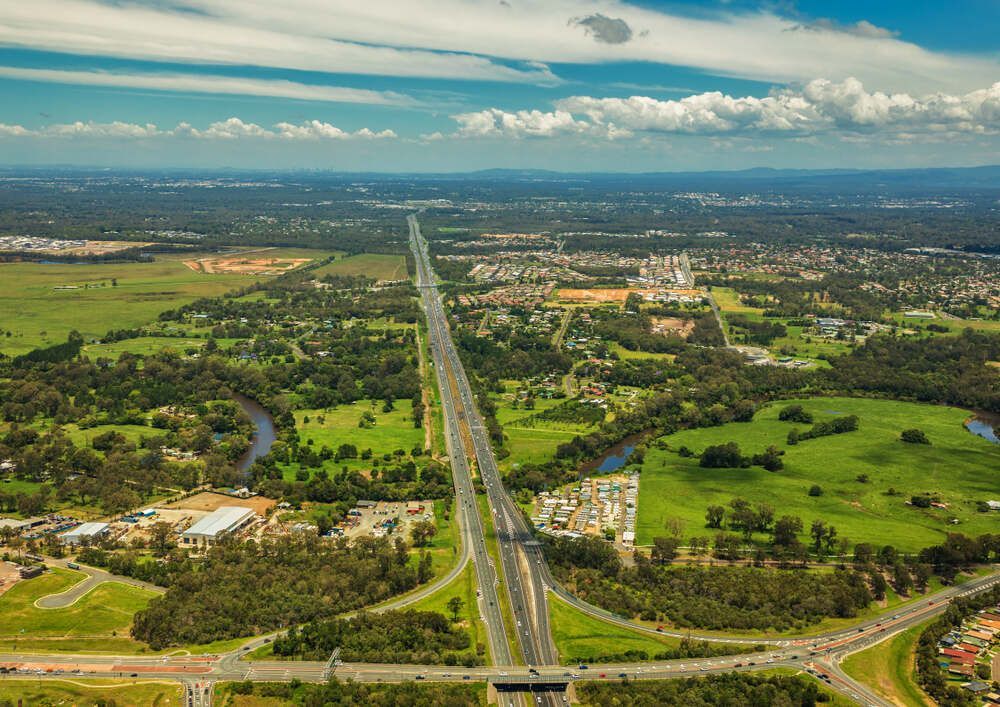 An Aerial View Of A Highway Going Through A Lush Green Countryside — Pete's Painting Solutions In Brinsmead, QLD