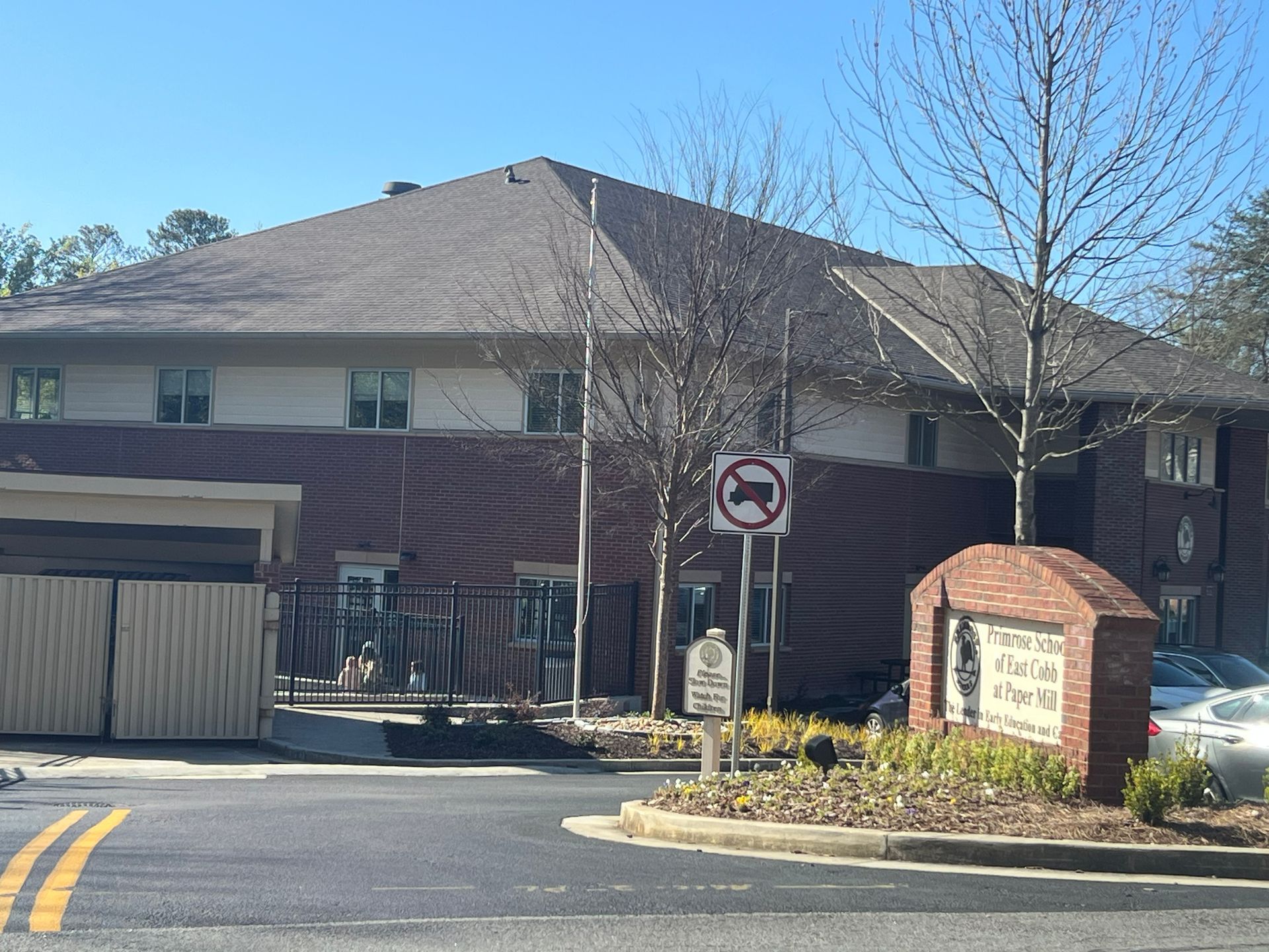 Apartment complex entrance with brick sign, no entry for trucks.