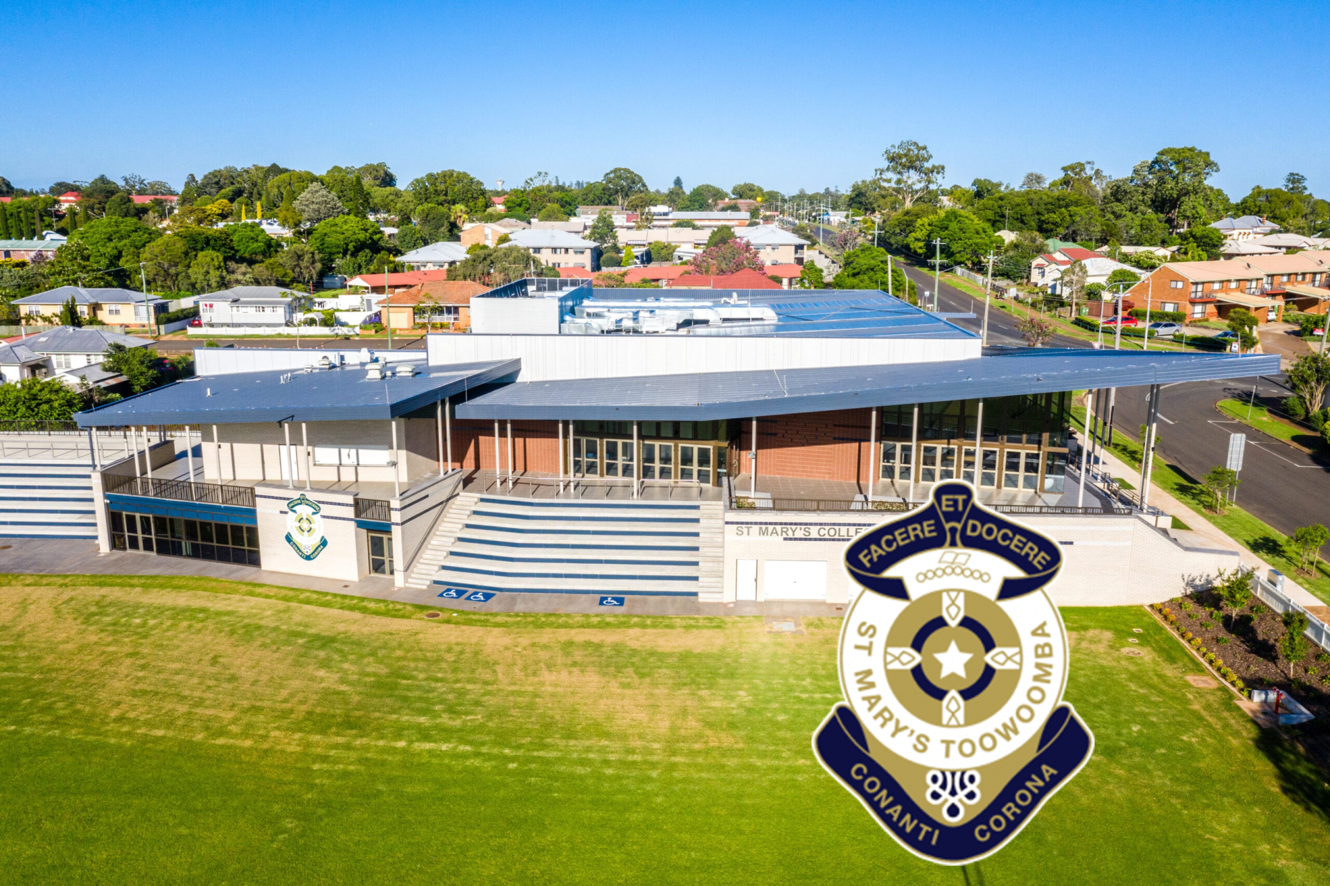 An aerial view of a large building with a shield on top of it.