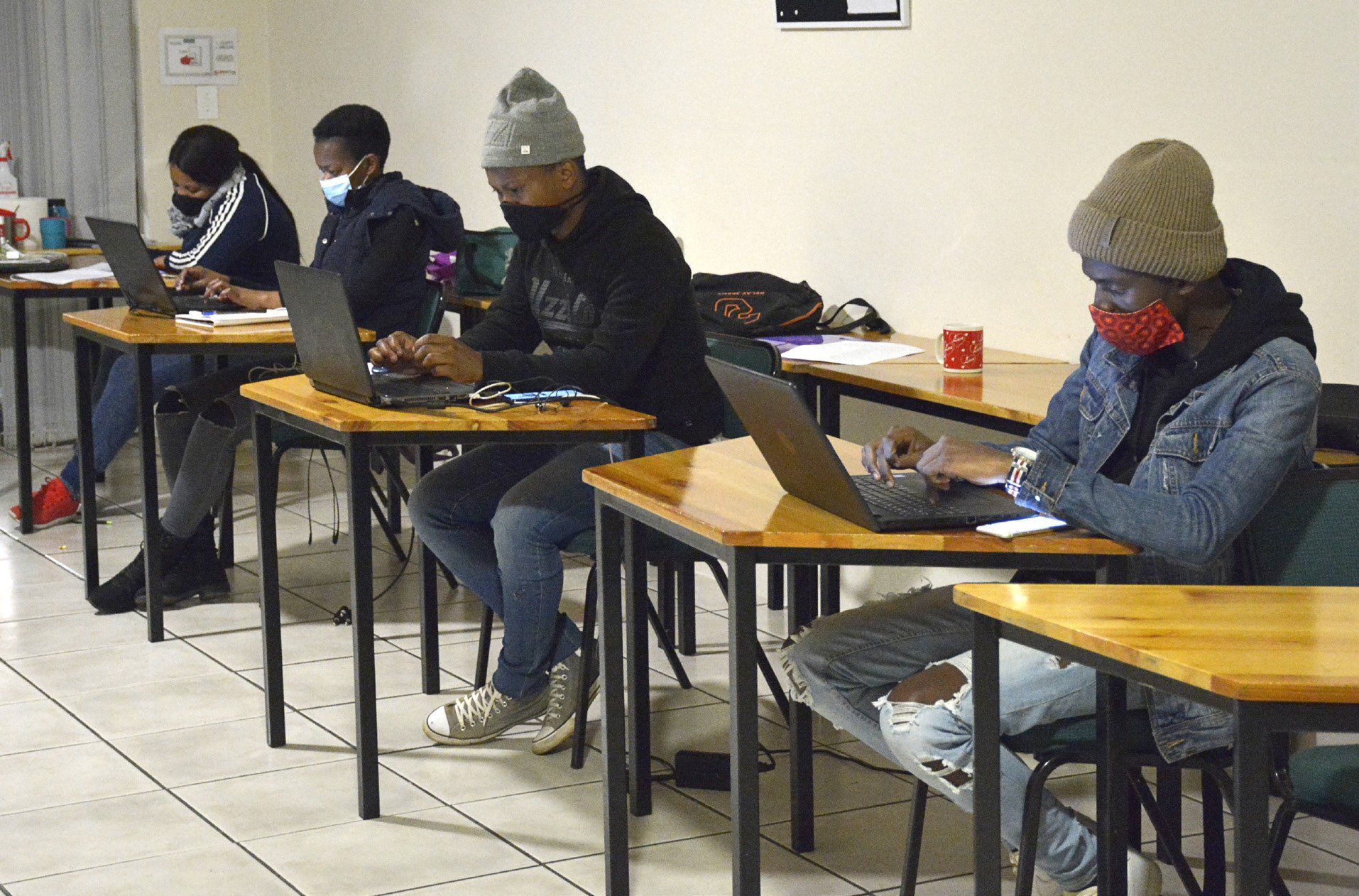 female lecturer pointing remote toward projection screen